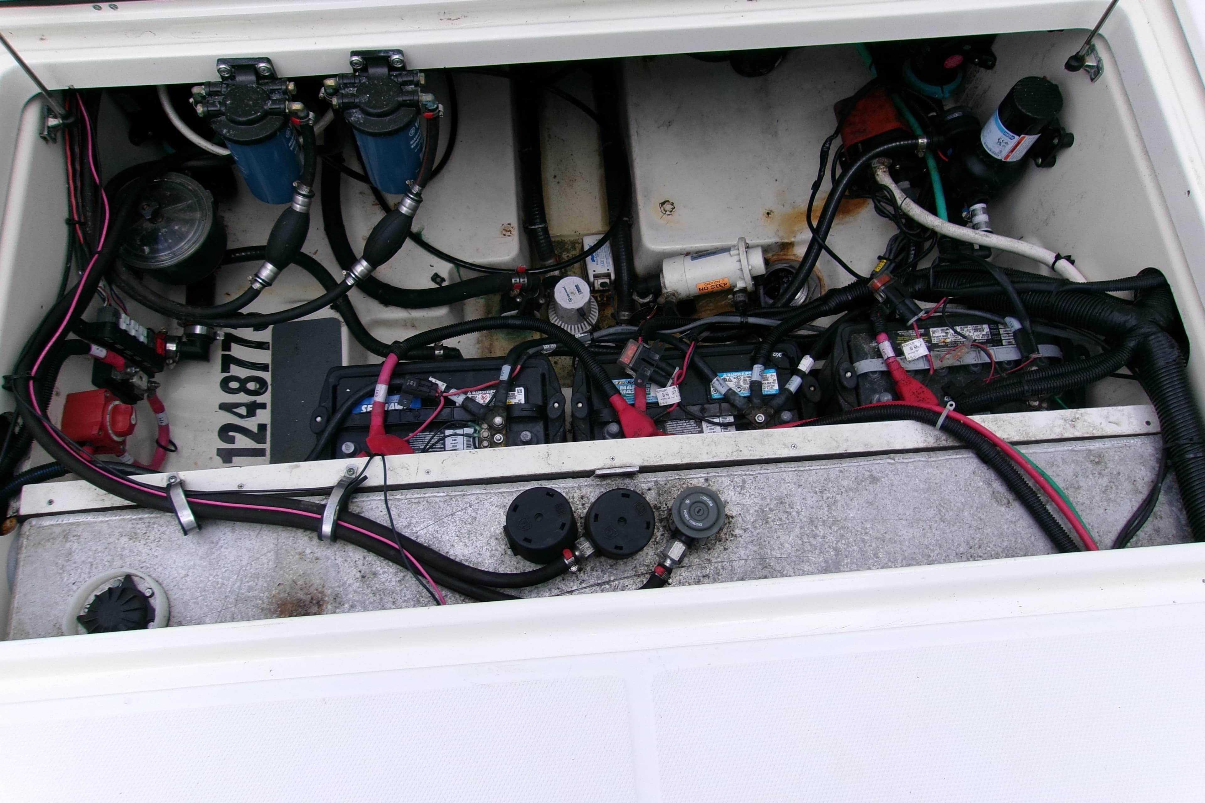 Engine compartment of a 2013 Boston Whaler 315 Conquest, showing wiring and components.