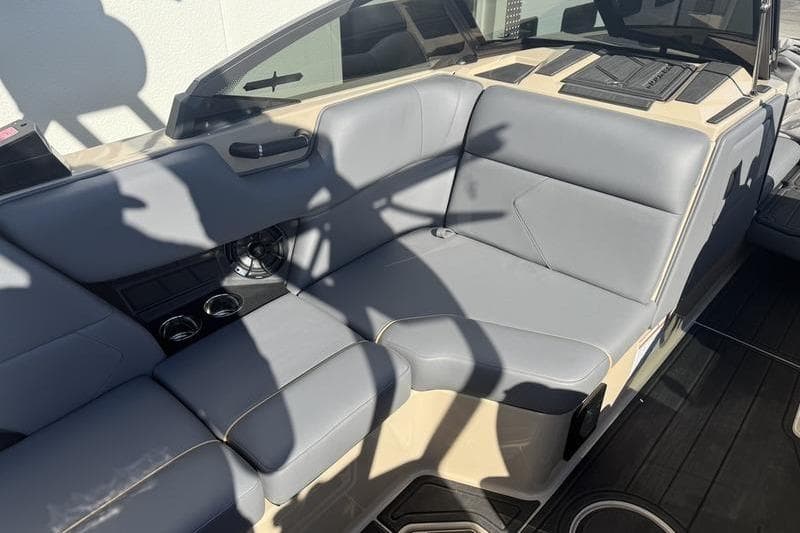 2025 Moomba Tykon boat interior with gray seating and cup holders.