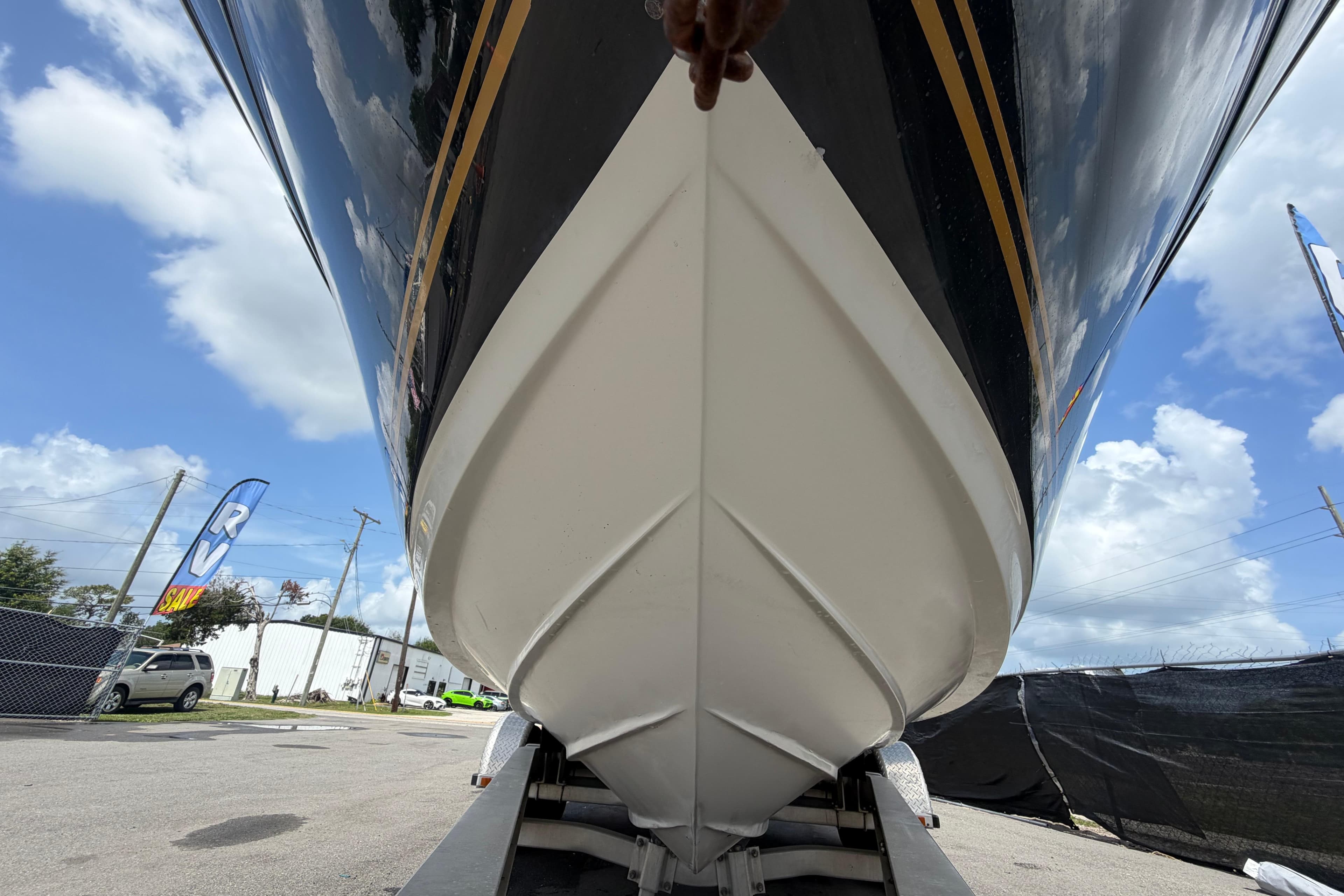 2006 Sea Ray 250 Amberjack boat hull on trailer under blue sky.
