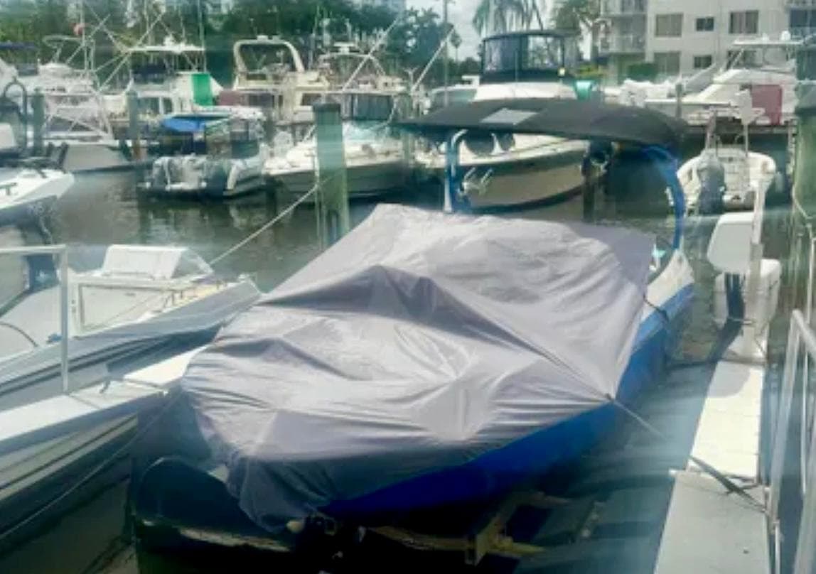 2019 Yamaha Boats 242X E-Series covered at marina dock.
