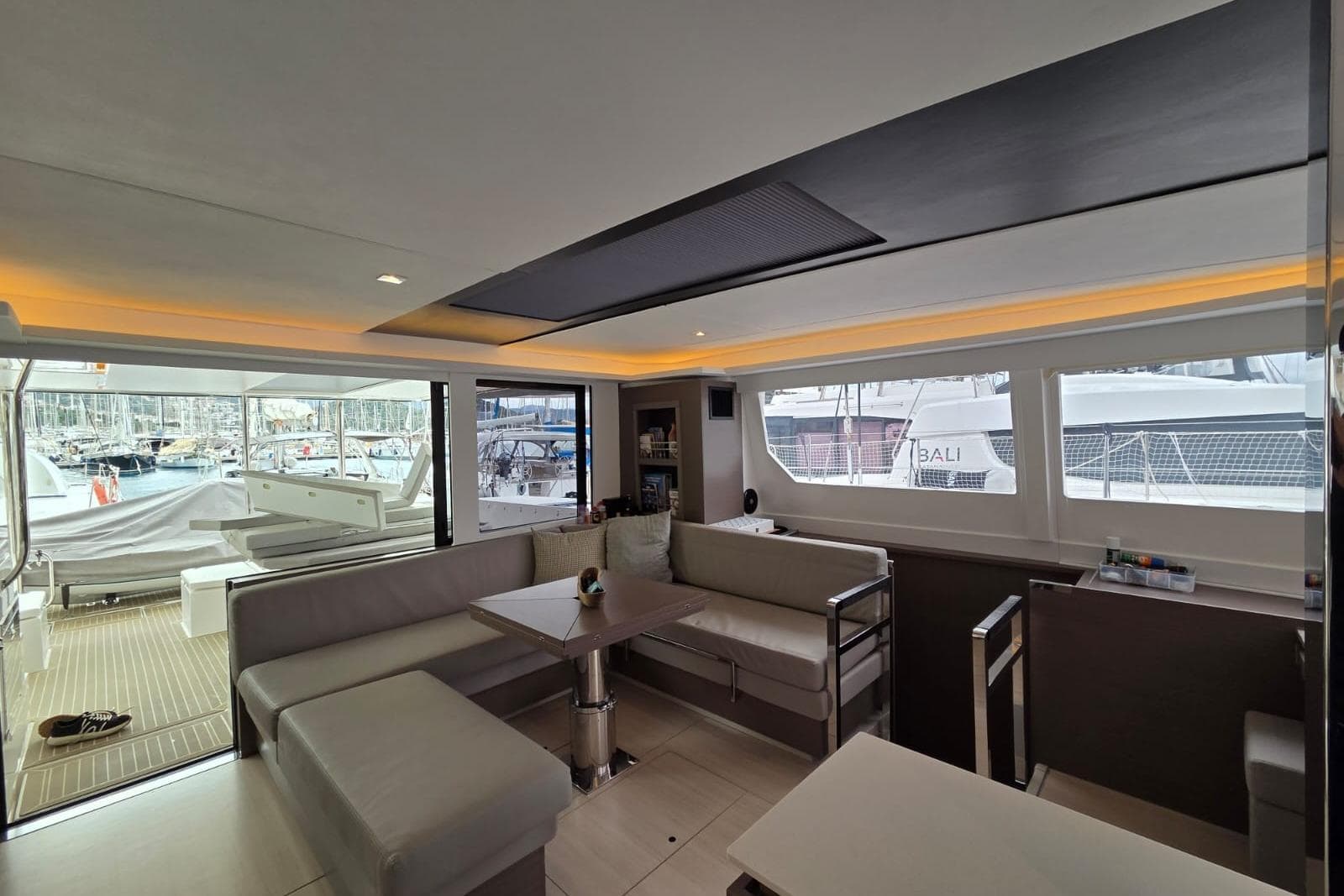 Luxurious interior of 2024 Leopard 50 yacht with spacious seating and marina view.