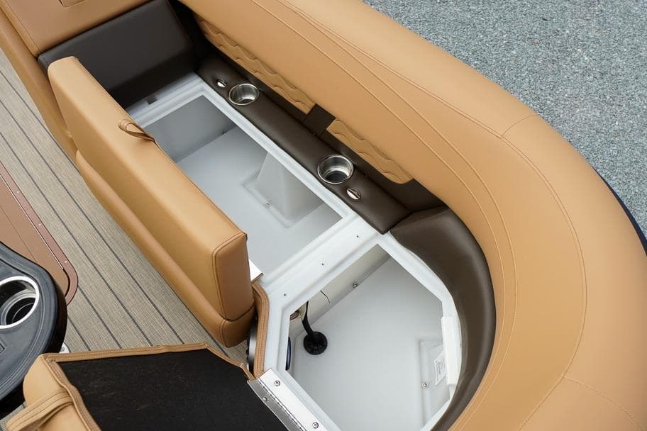 2026 SunCatcher Fusion 324RC boat interior with tan seating and built-in storage compartments.