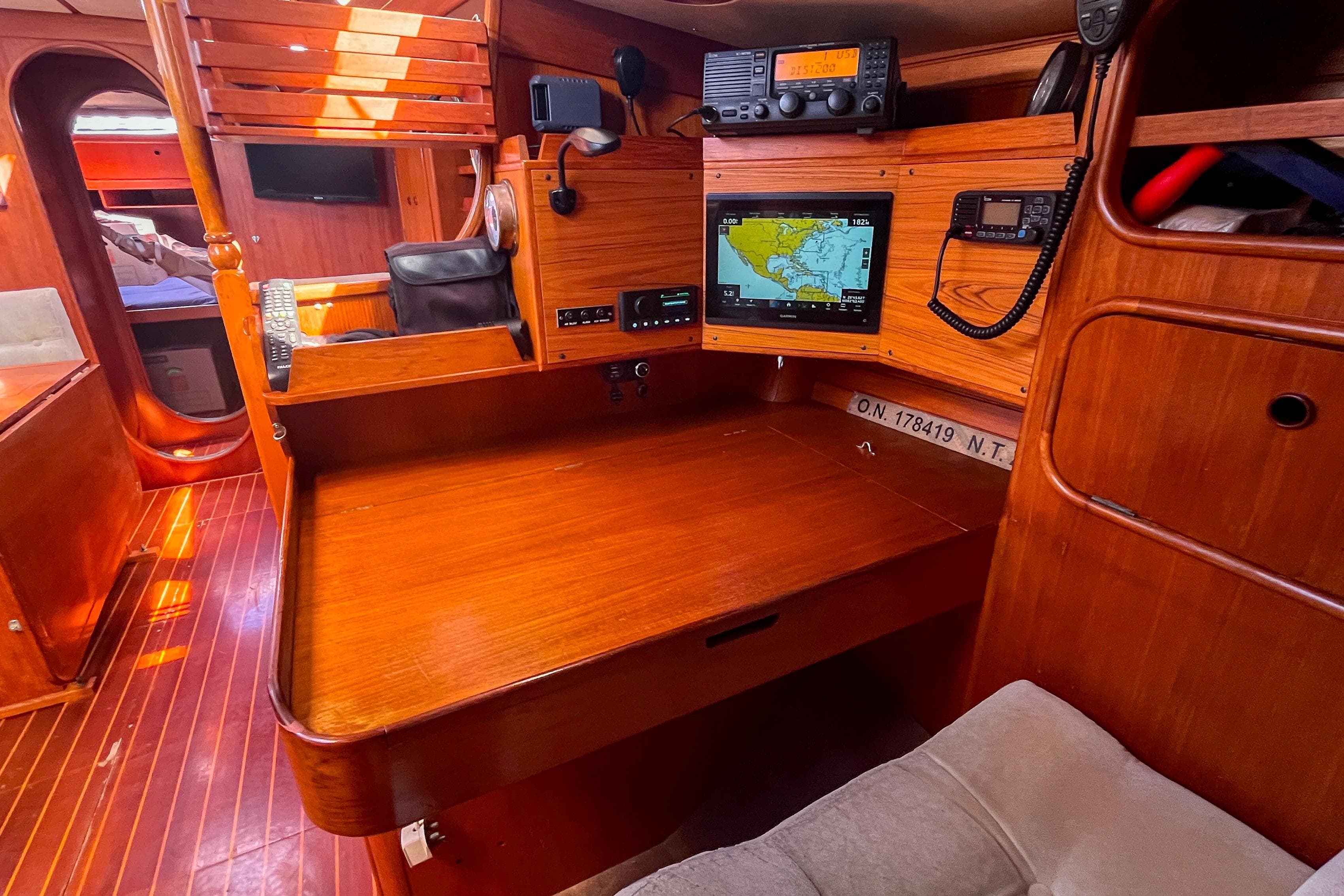 1991 Oyster LW48 yacht interior with navigation equipment and wooden furnishings.