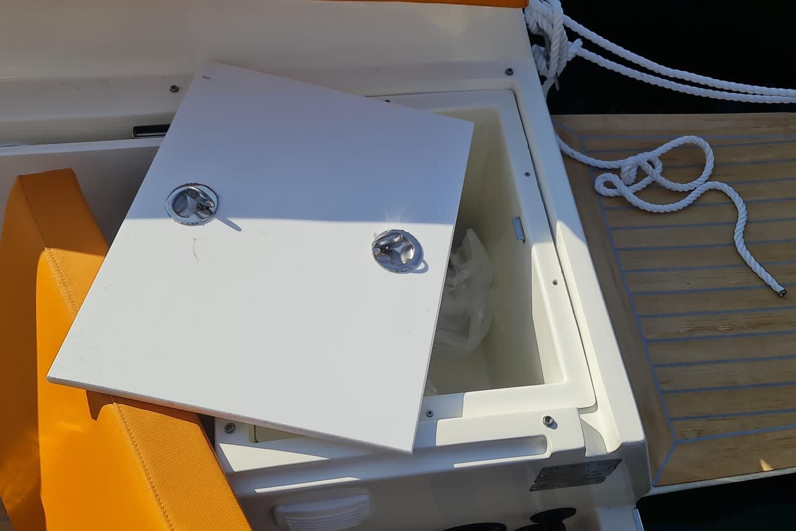 Open storage compartment on 2025 NUVA YACHTS M6 Fisher boat deck.