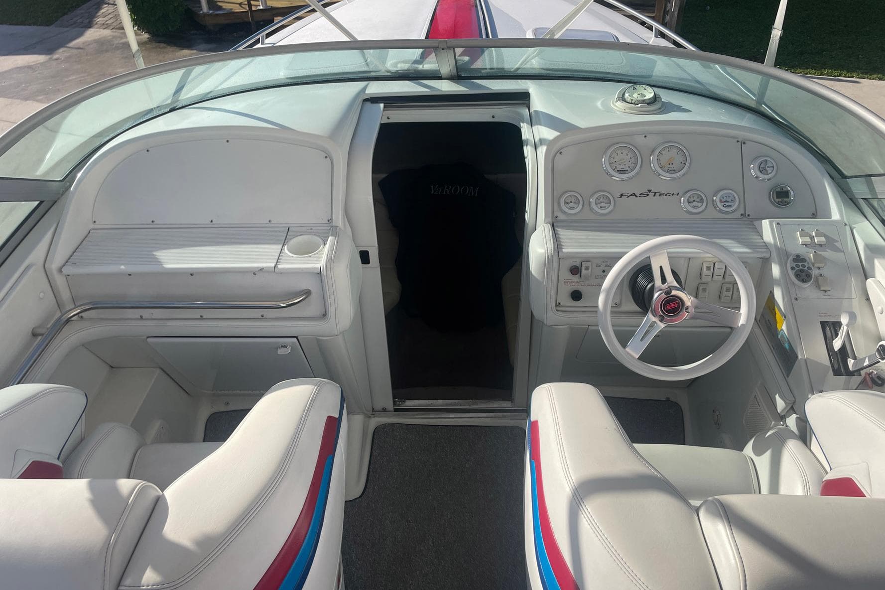 2001 Formula 271 FASTech boat cockpit with white seating and control panel.