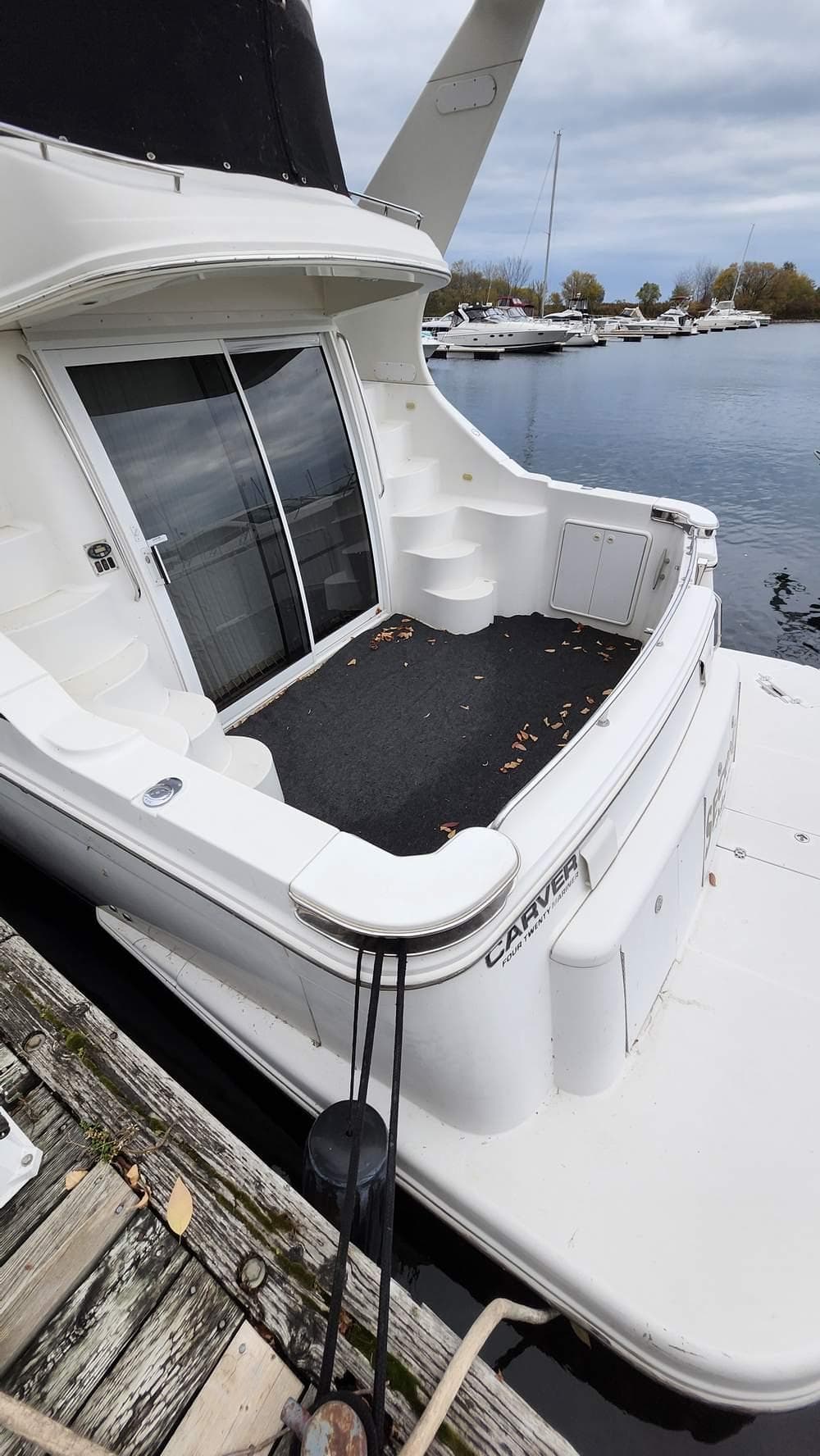 2005 Carver 420 Mariner yacht docked at a marina, rear view.