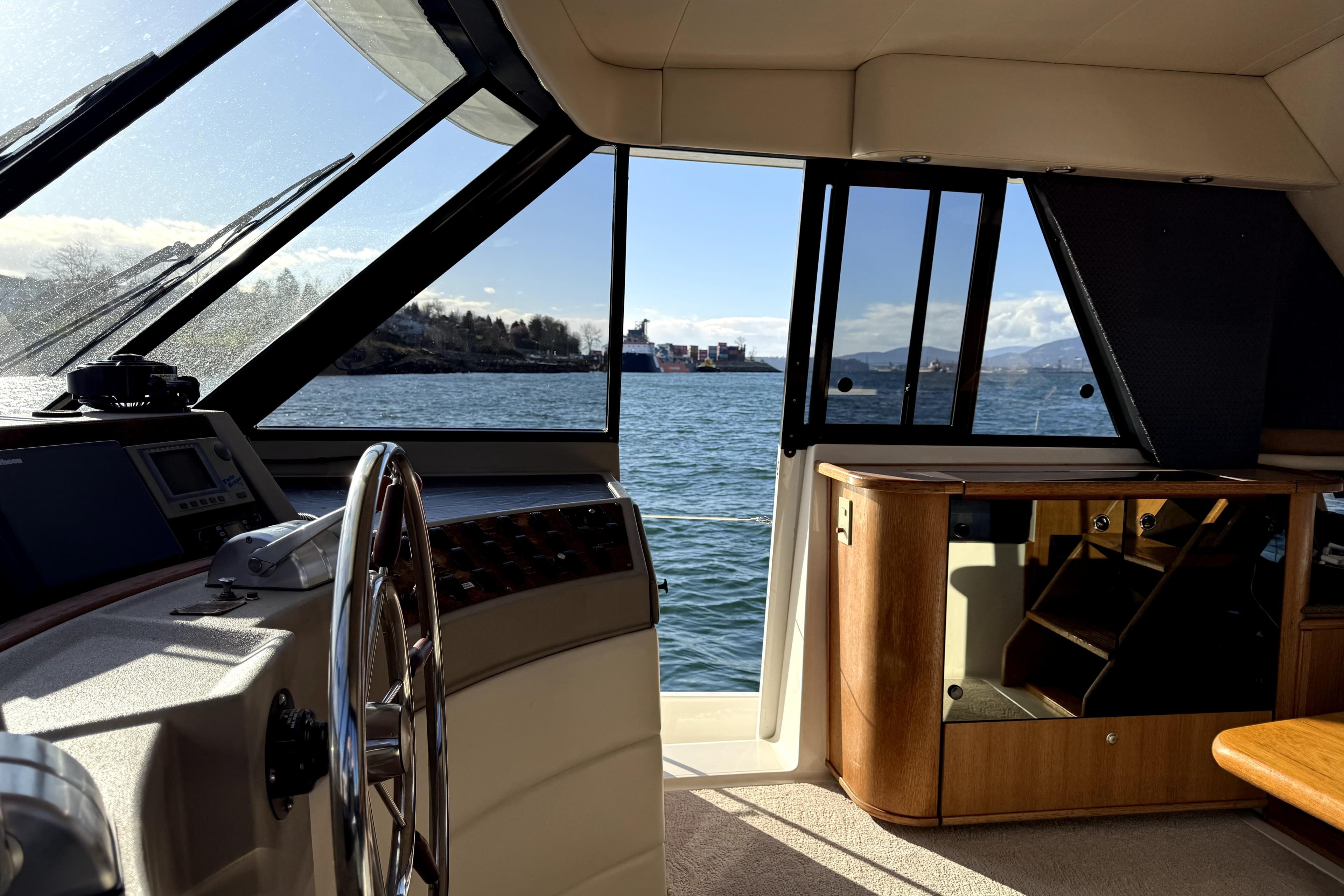 Interior view of 1998 Bayliner 4788 Pilot House Motoryacht with ocean scenery.