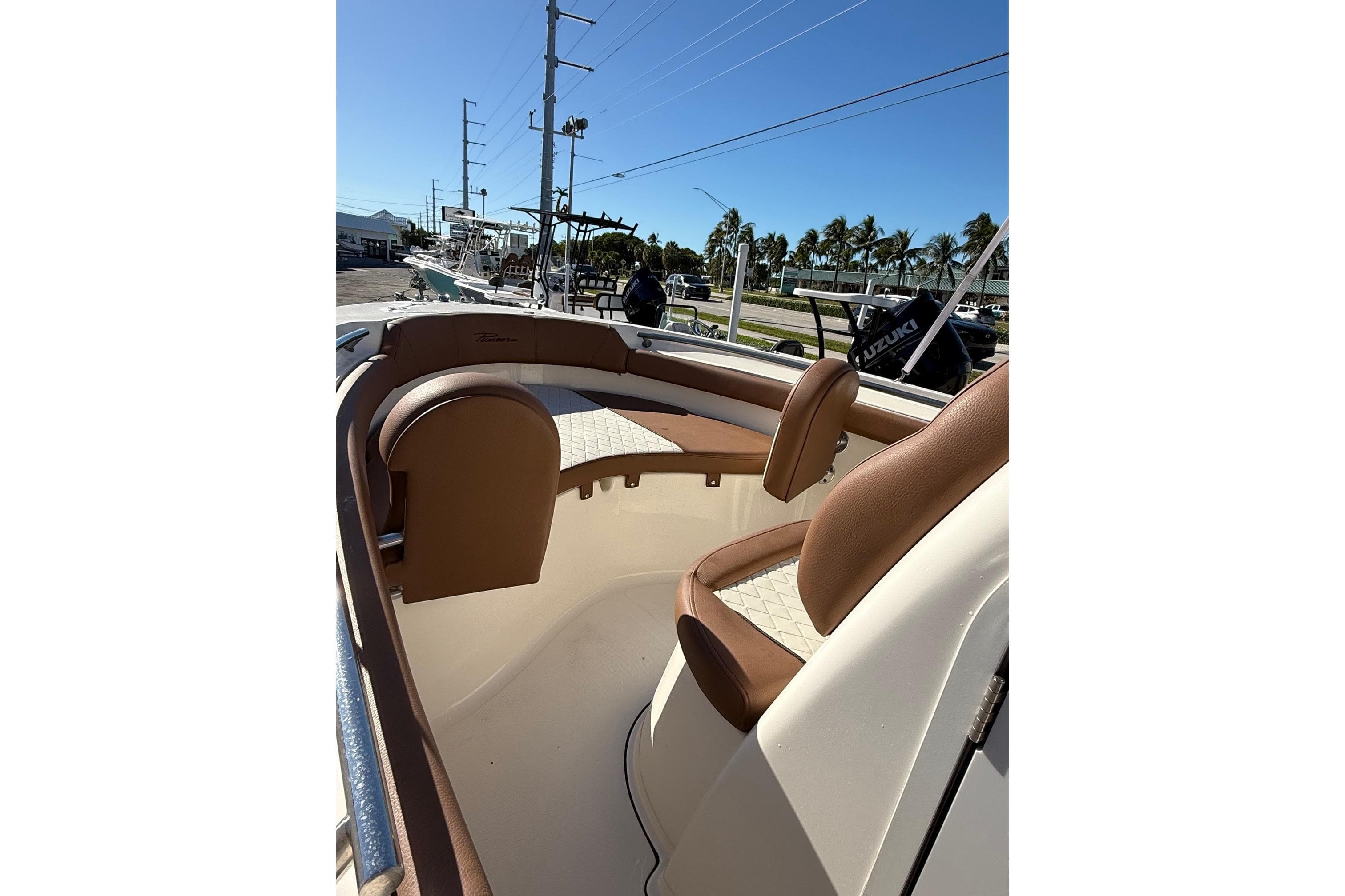 2023 Pioneer 202 Islander boat interior with brown seating and open deck.
