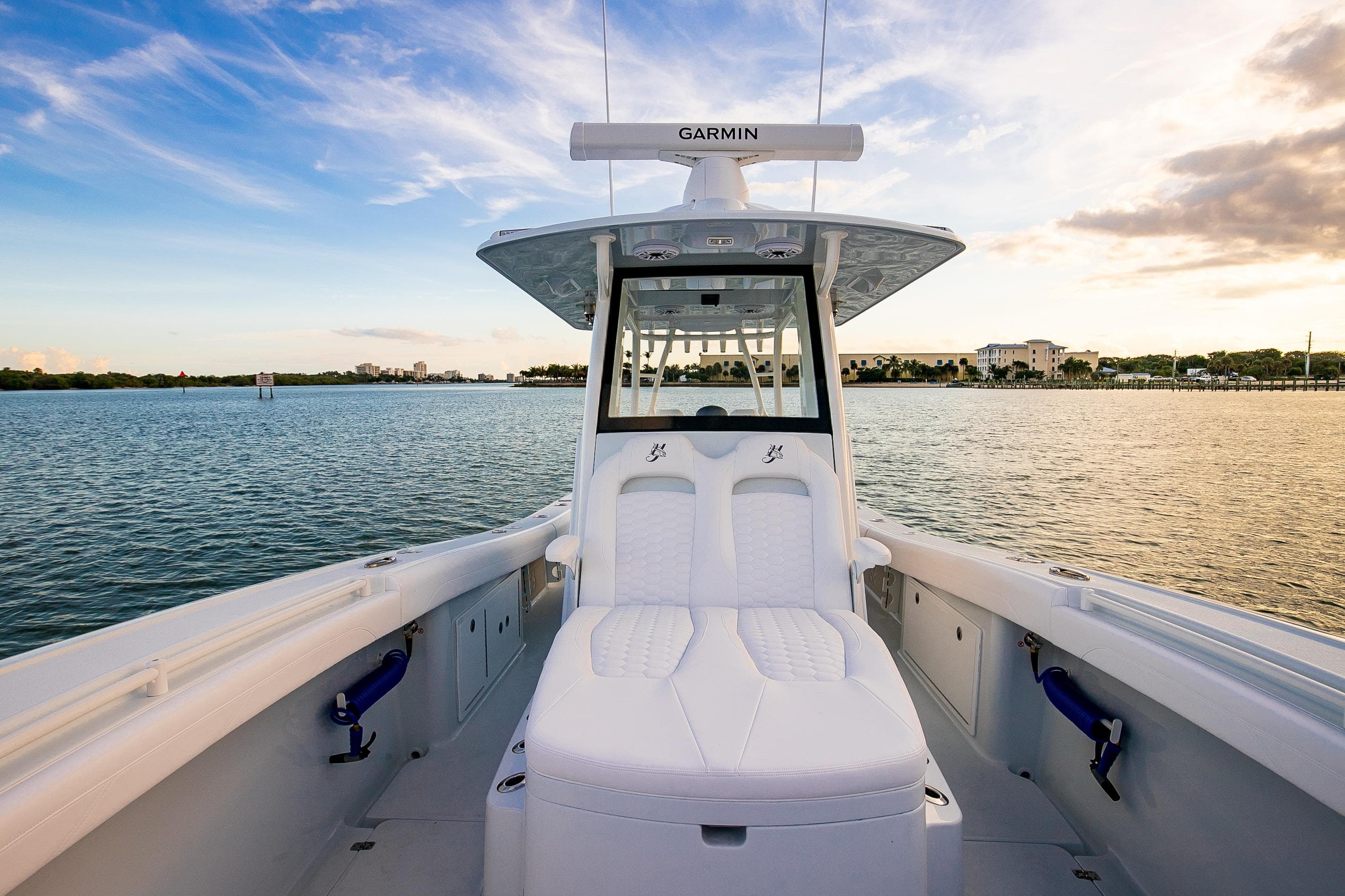 2026 Yellowfin 36 Offshore boat on calm water at sunset, featuring Garmin equipment.