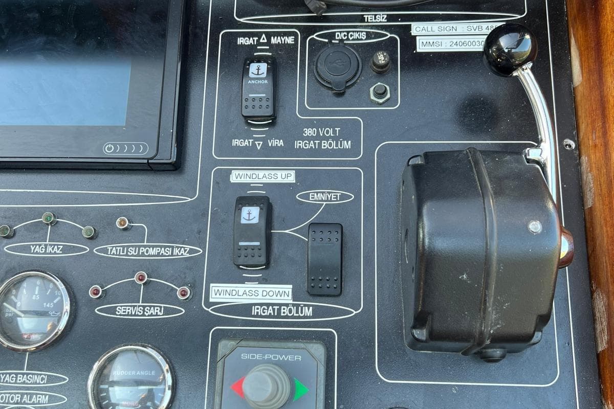 Control panel of the 1993 Custom Sailing Yacht Ocean Pure, featuring various switches and gauges.