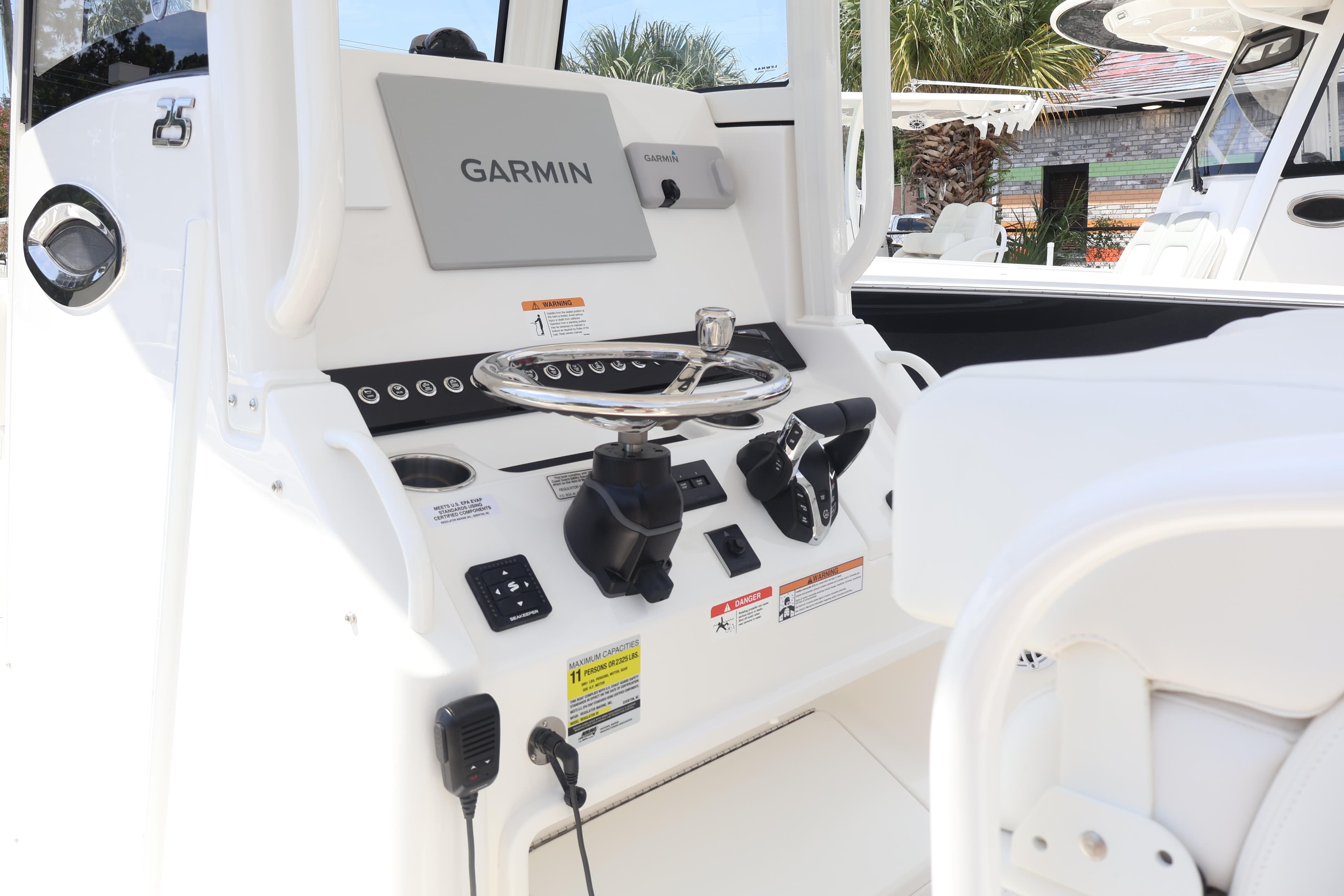 2026 Regulator 25 boat dashboard with Garmin navigation system and steering wheel.