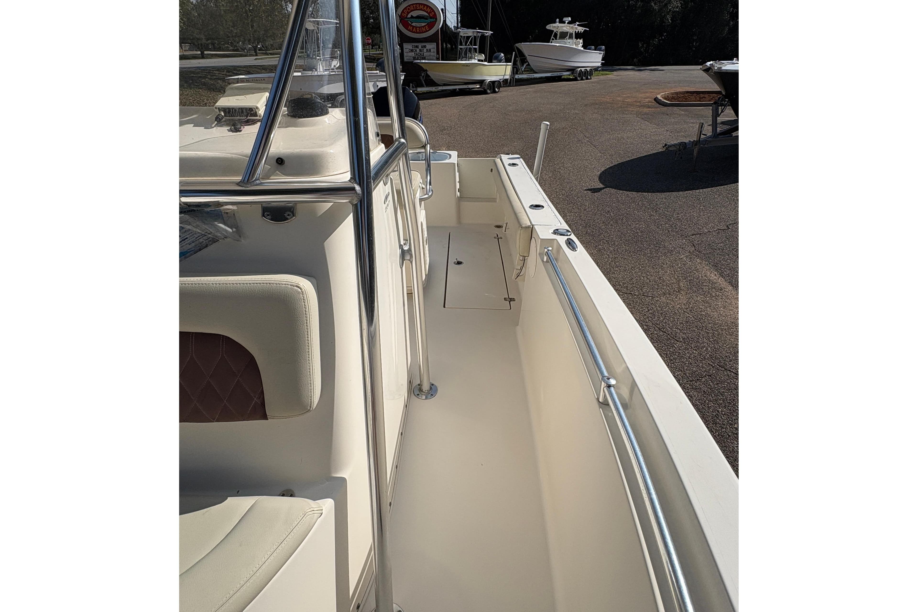 2021 Cobia 237 Center Console boat, side view with seating and railing.