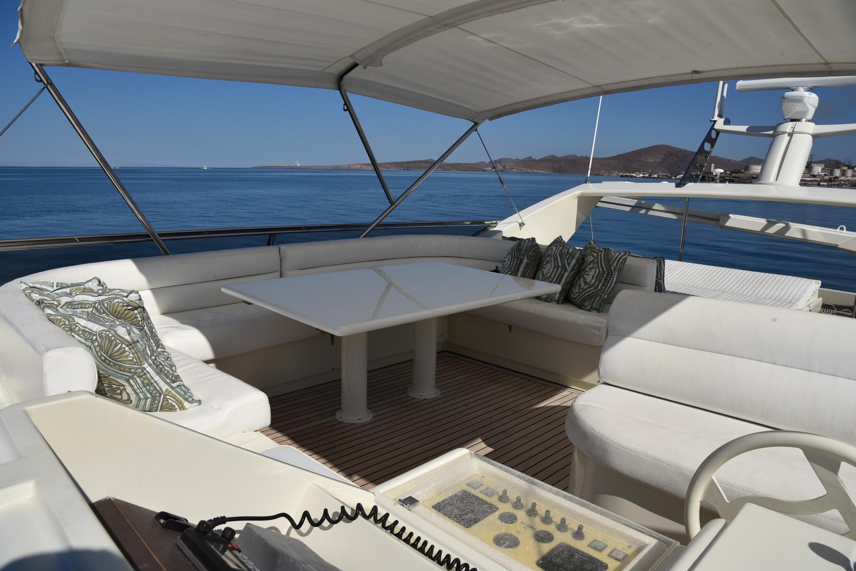 Luxurious 1997 Ferretti Yachts 80 with spacious outdoor seating and ocean view.