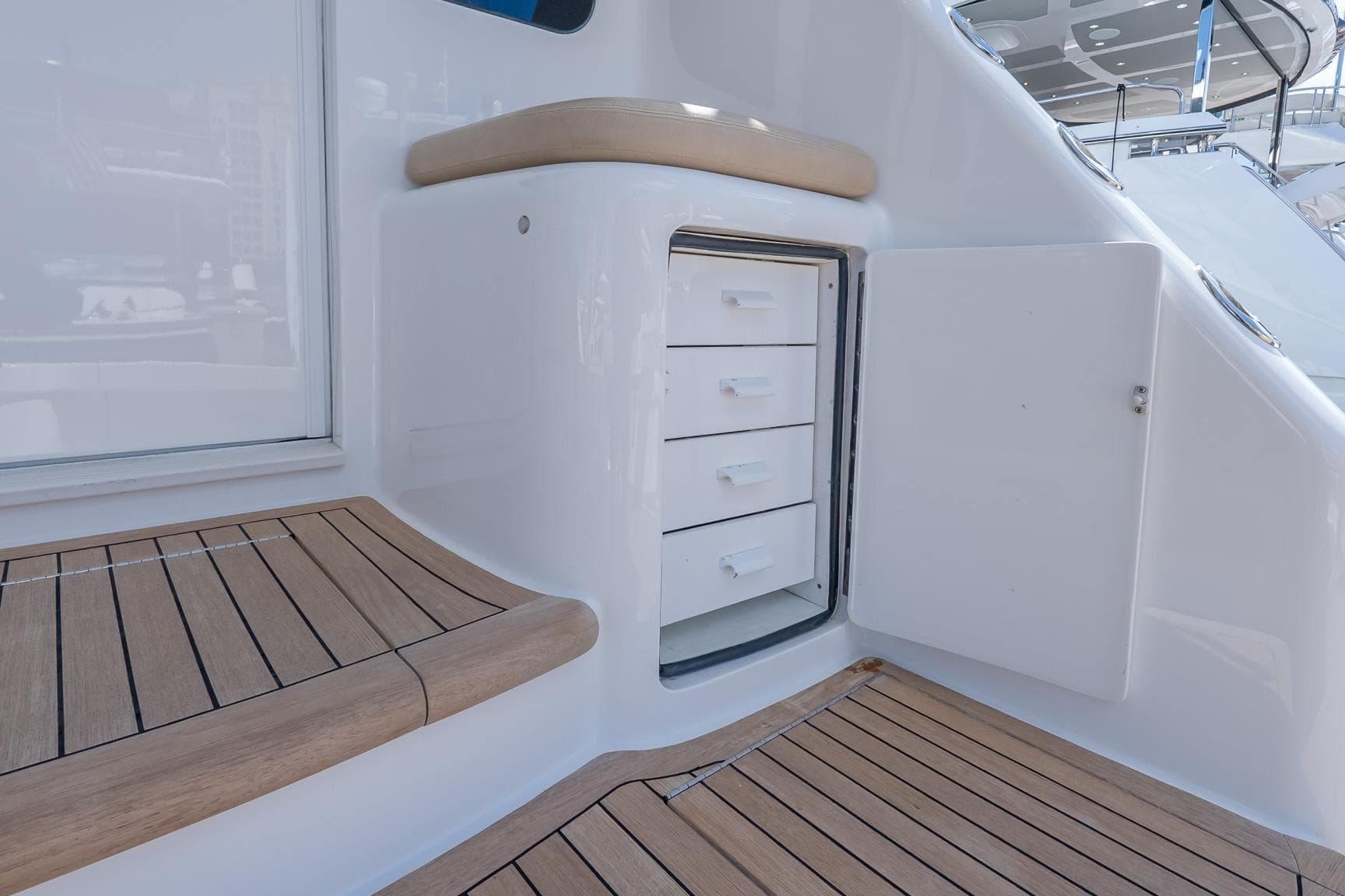 Interior view of 2017 Viking 62 Enclosed Bridge yacht with wooden flooring and storage drawers.