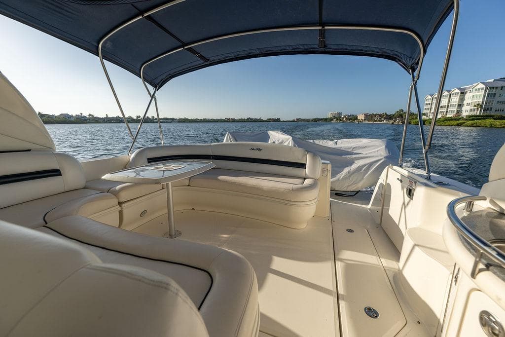 2005 Sea Ray 420 Sundancer yacht interior with seating and table, cruising on a sunny day.