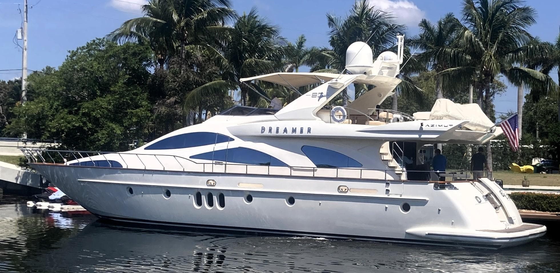 2005 Azimut 80 Carat yacht docked by palm trees, named "Dreamer."