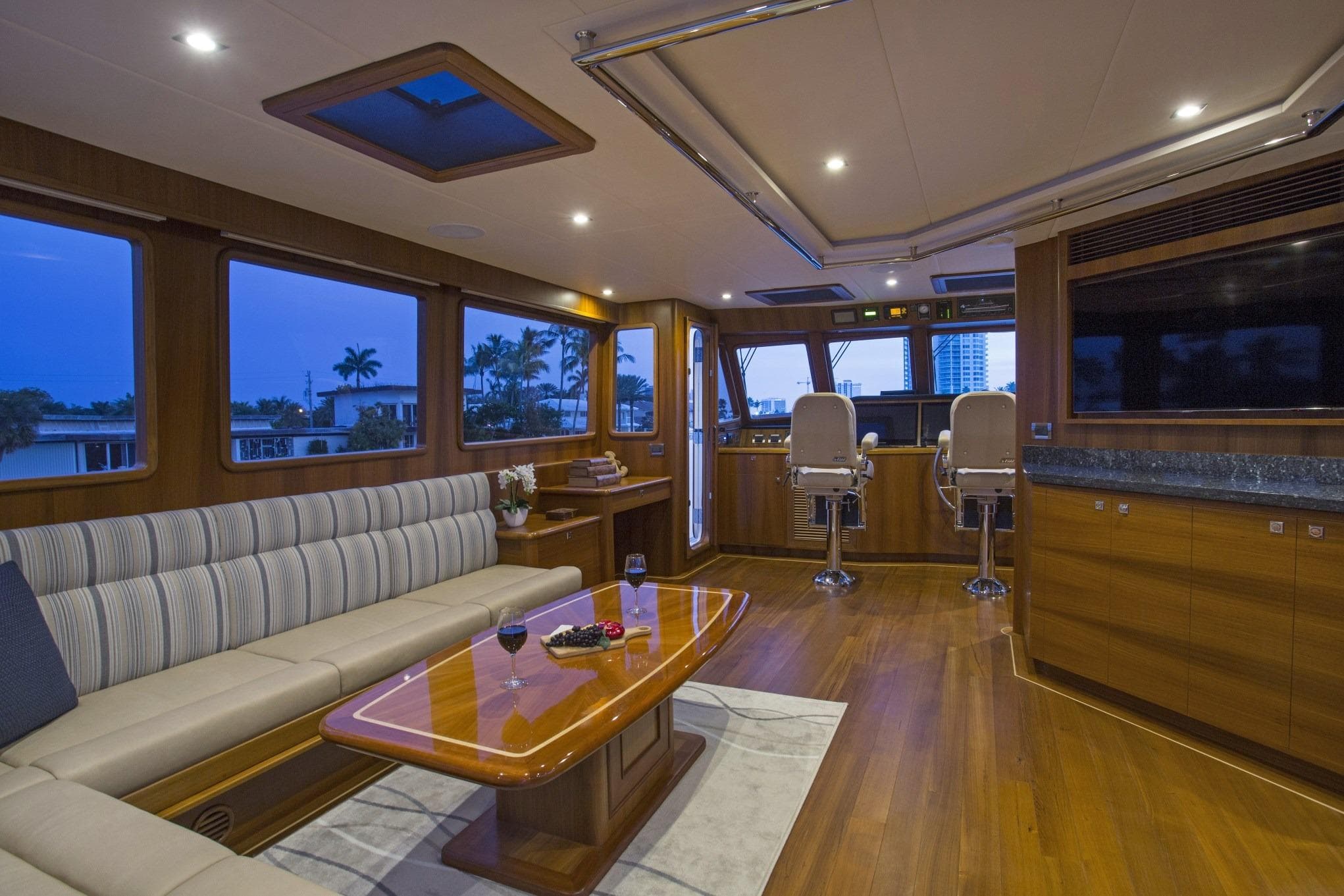 Luxurious interior of 2027 Outer Reef Yachts 860 Deluxbridge Motoryacht with elegant seating and helm.