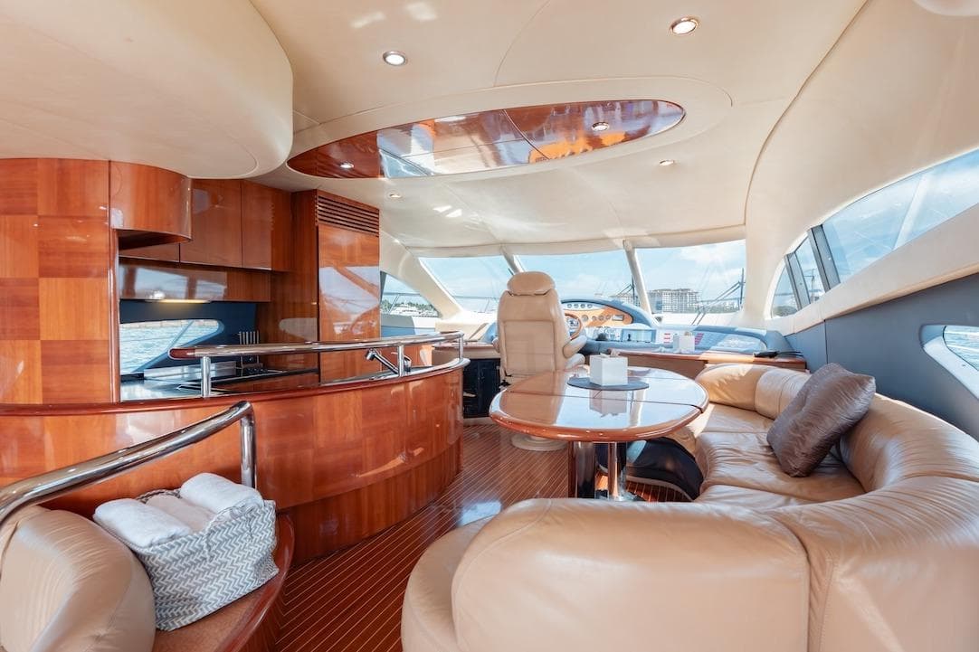 Luxurious interior of 2007 Azimut 62 Evolution yacht with elegant wood and leather furnishings.
