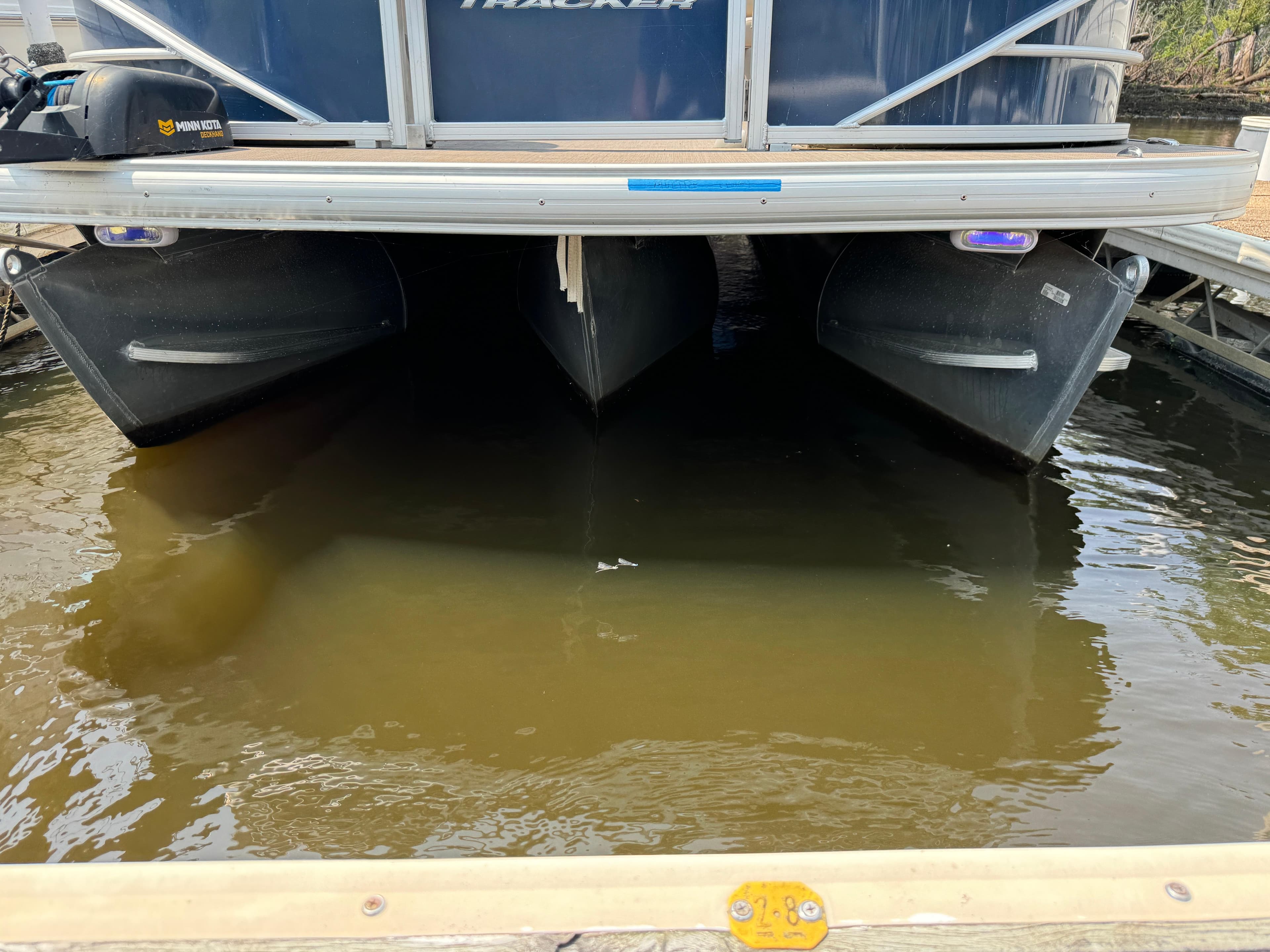 2020 Sun Tracker Party Barge 22 Tri Toon RF XP3 pontoon boat in water, docked.