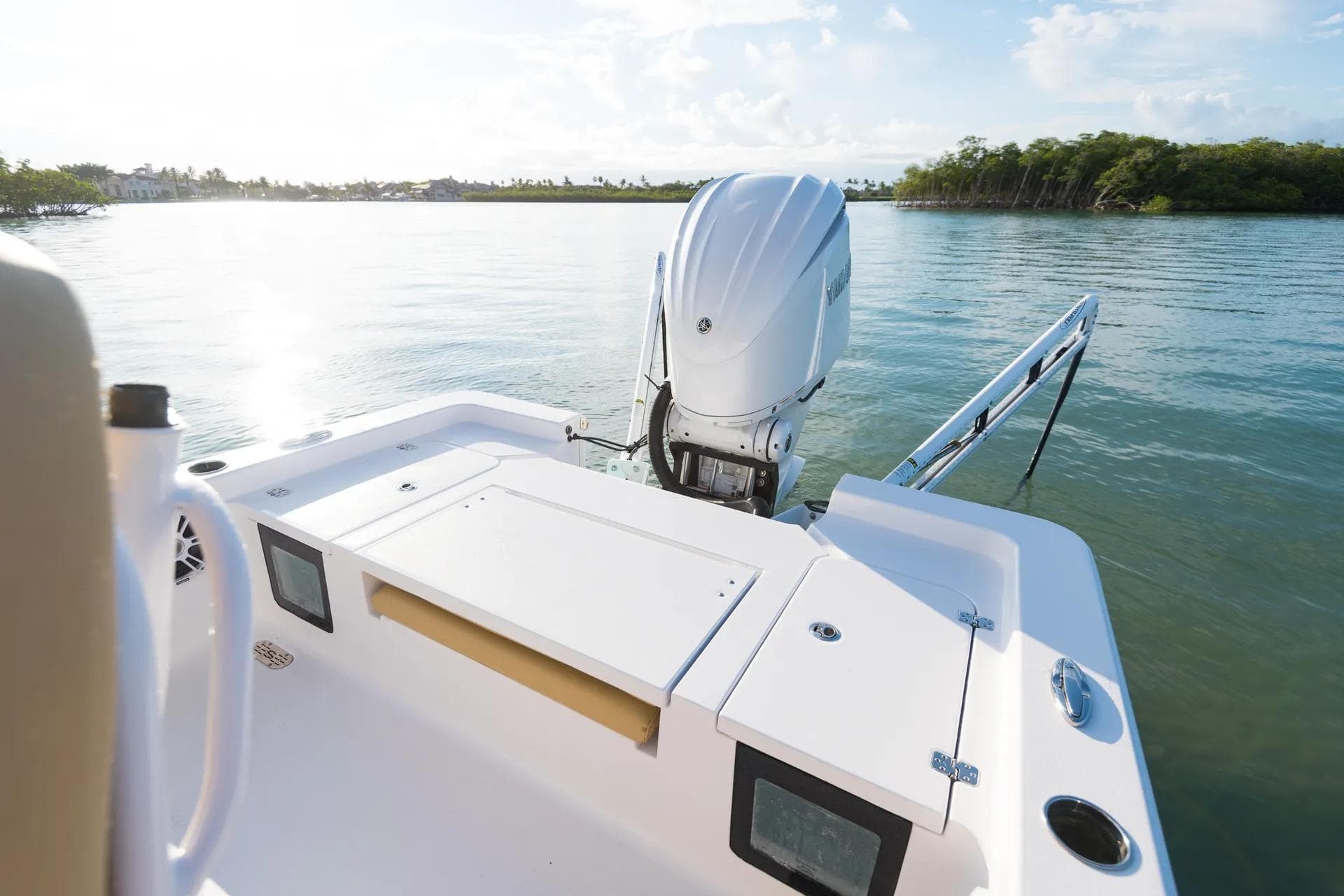 2026 Sportsman Masters 247 Bay Boat on calm water, featuring a powerful outboard motor.