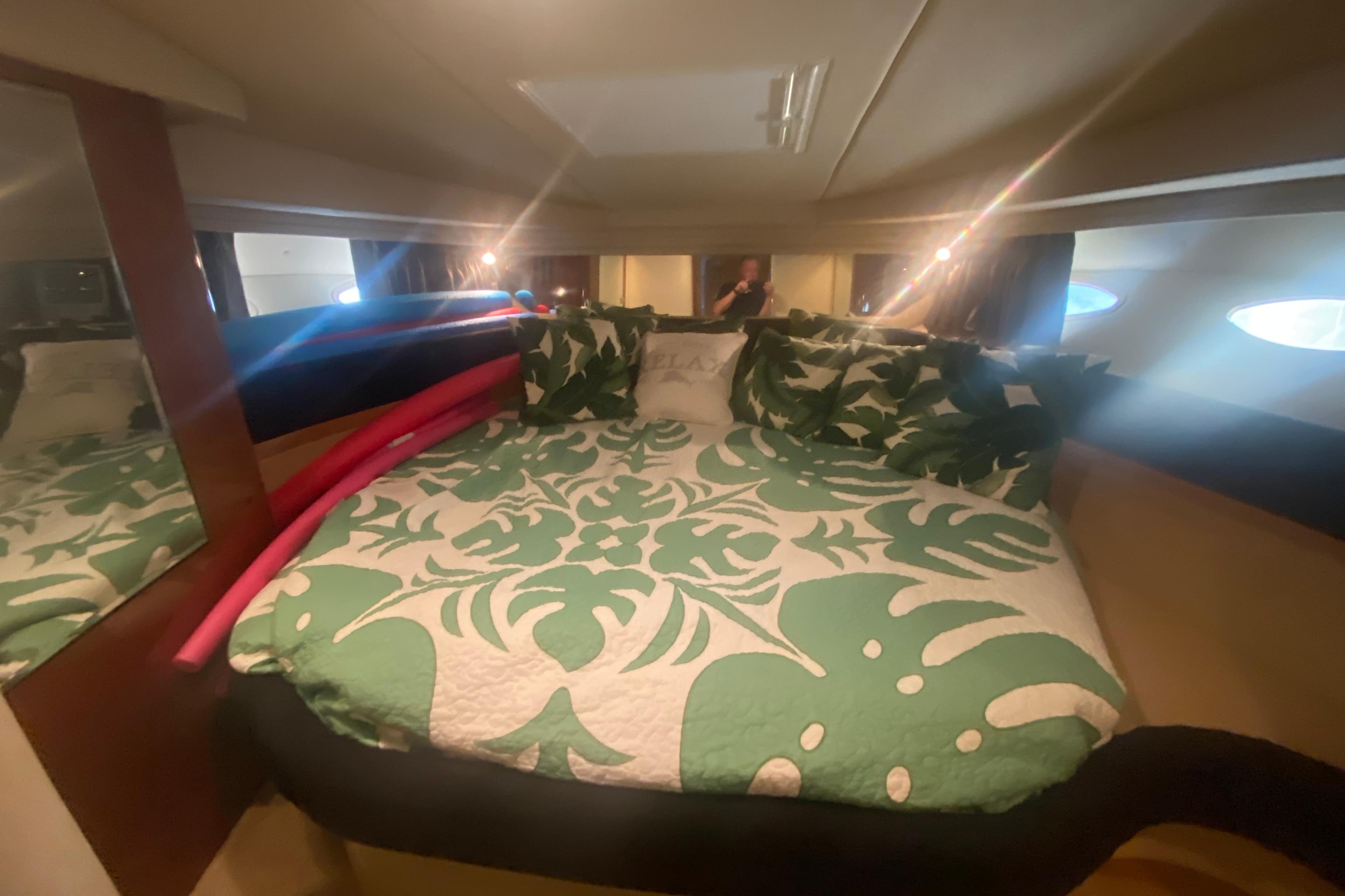 Luxurious cabin interior of 2004 Sea Ray 380 Sundancer with tropical bedding.