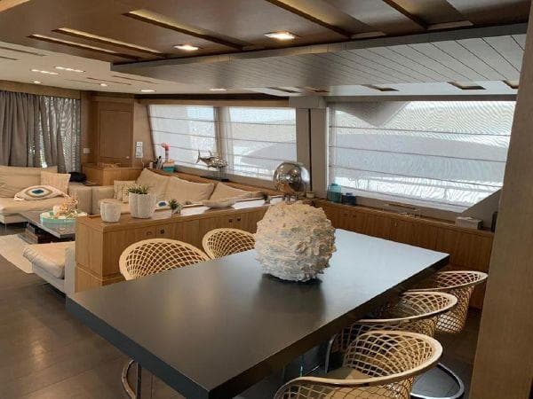 Luxurious interior of 2011 Ferretti Yachts Custom Line 100 with modern dining area and seating.