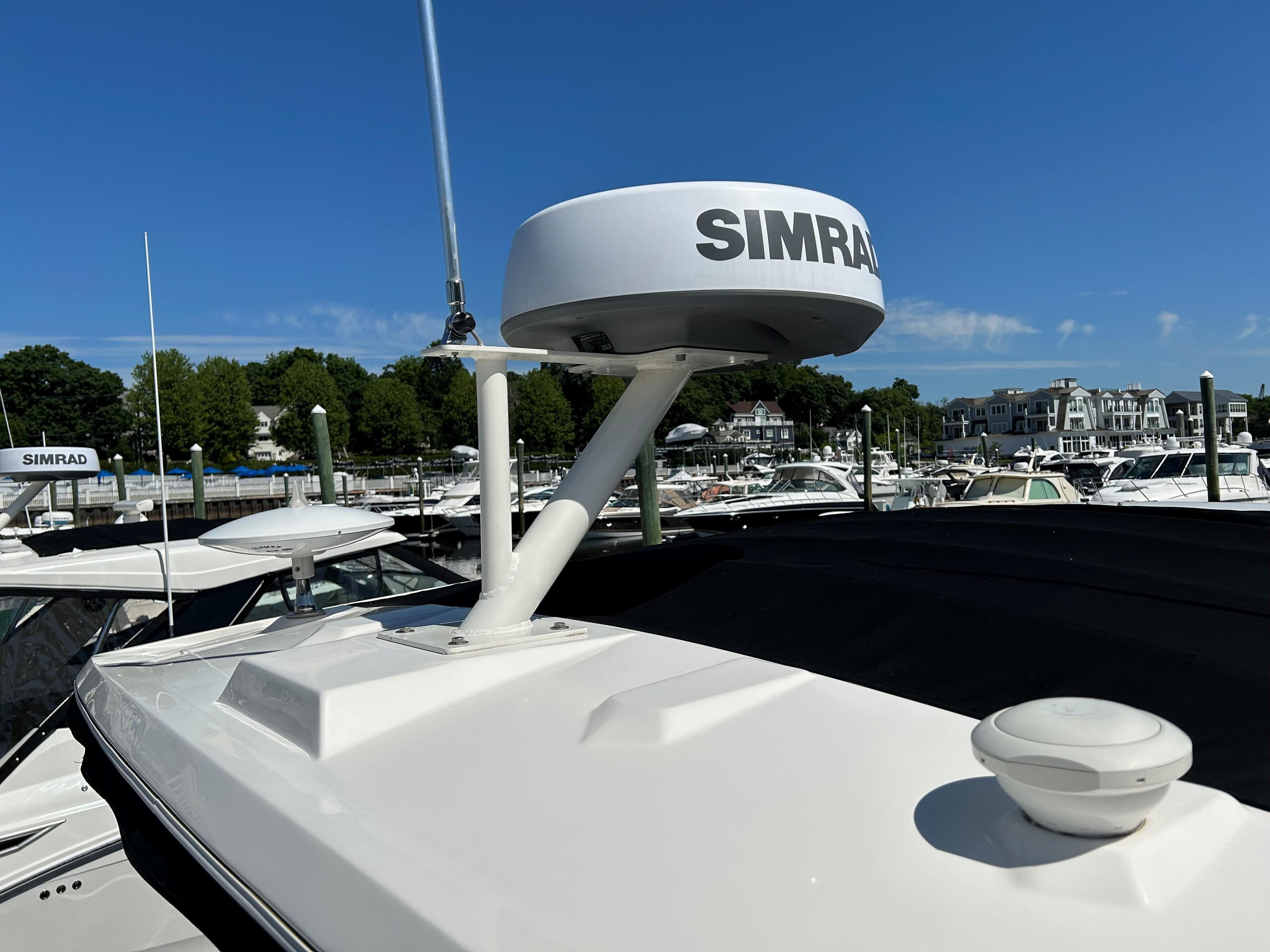 Sea Ray 320 DA 2021 boat with Simrad radar at marina.