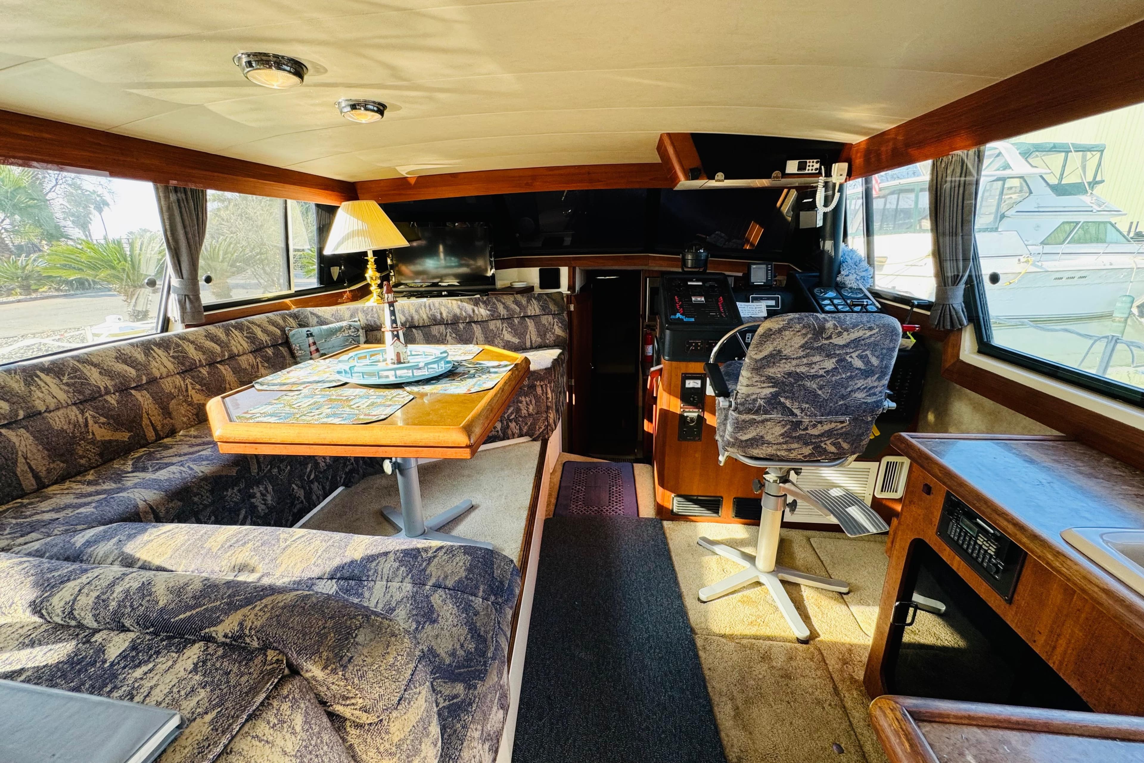1990 Bayliner 3888 Motoryacht interior with dining area and helm station.