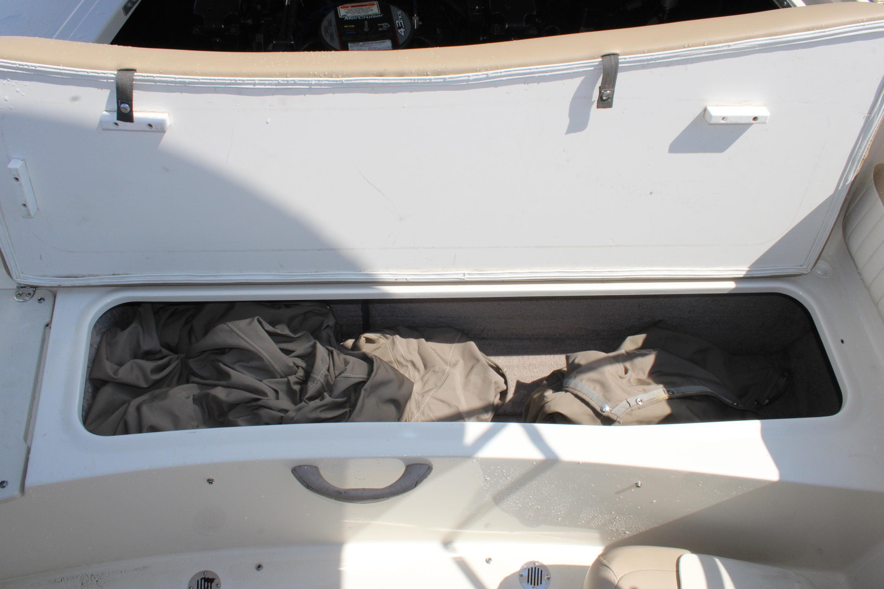 Open storage compartment in a 2014 Stingray 198 LF boat, containing fabric items.