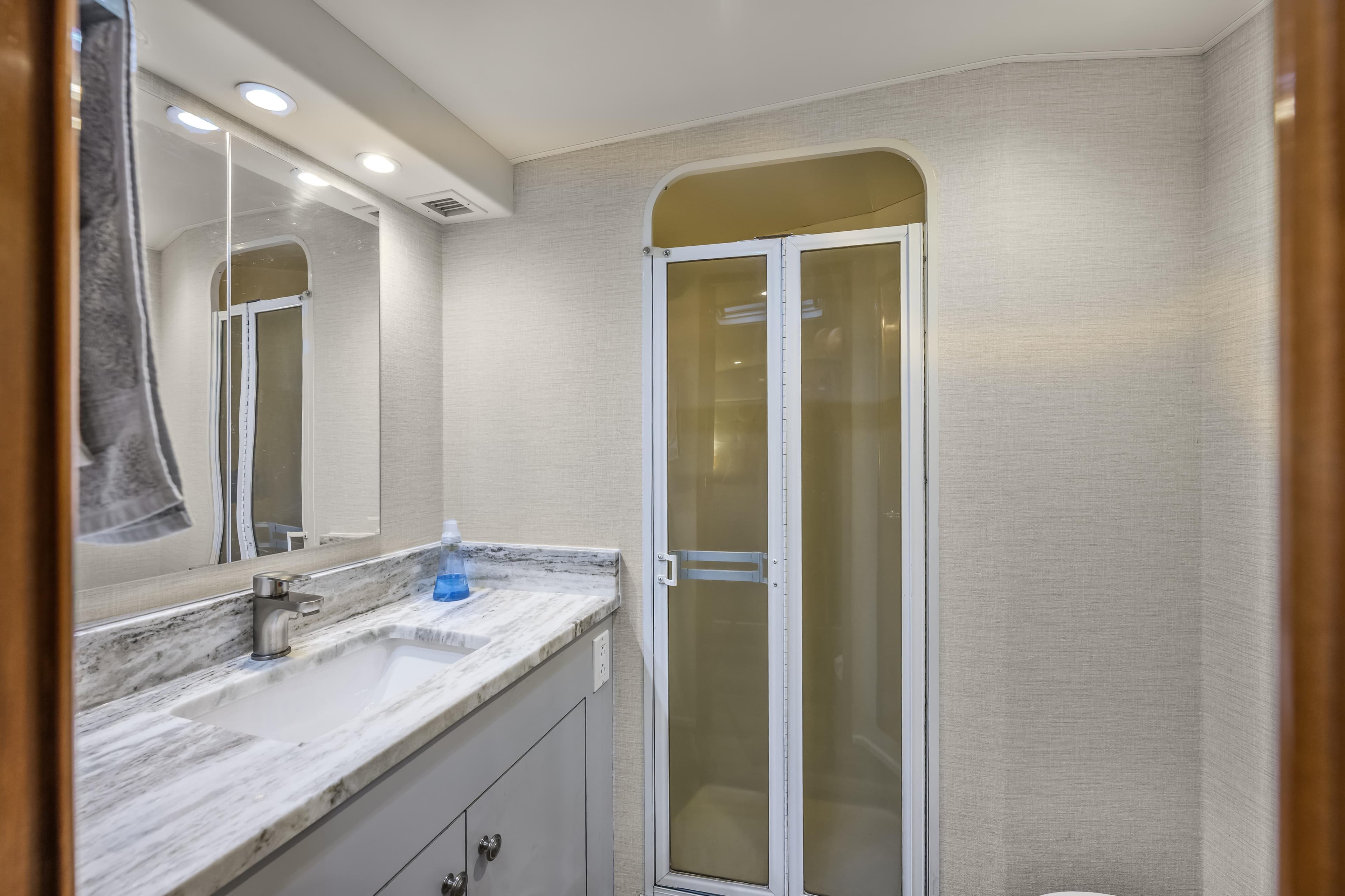 Bathroom interior of 1999 Viking 58 Convertible yacht with modern fixtures and shower.
