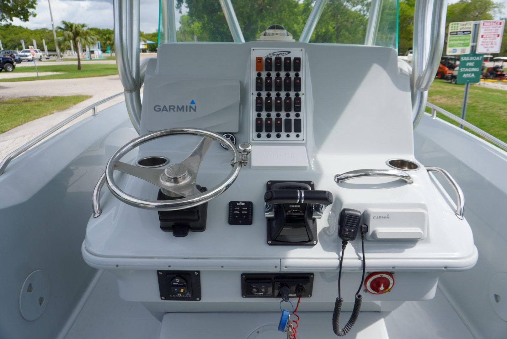 2004 Baja 340 Sportfish helm with Garmin navigation, steering wheel, and control panel.