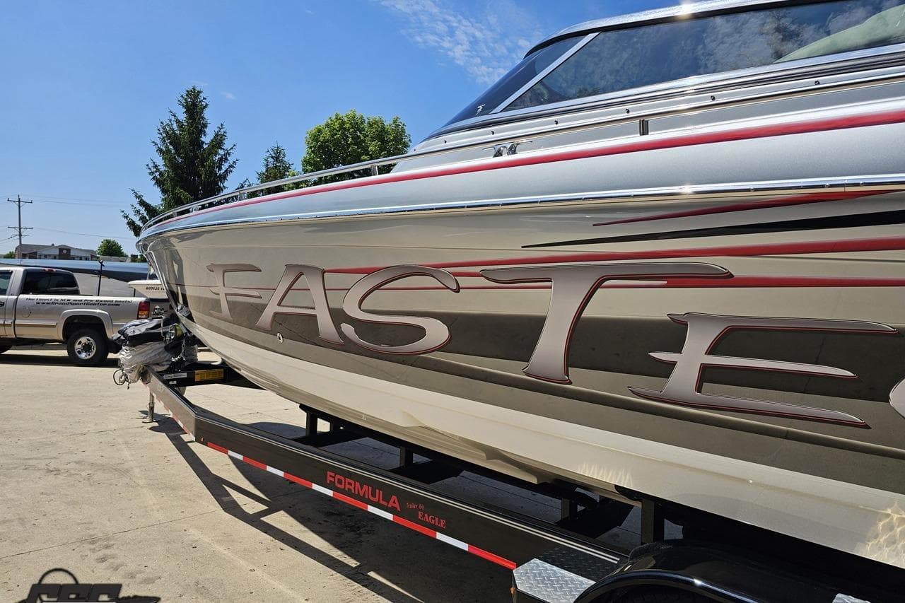 2012 Formula 353 FASTech boat on trailer, showcasing sleek design and branding.