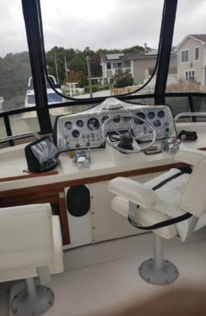 1985 Silverton 40 Double Cabin boat helm with steering wheel and navigation instruments.