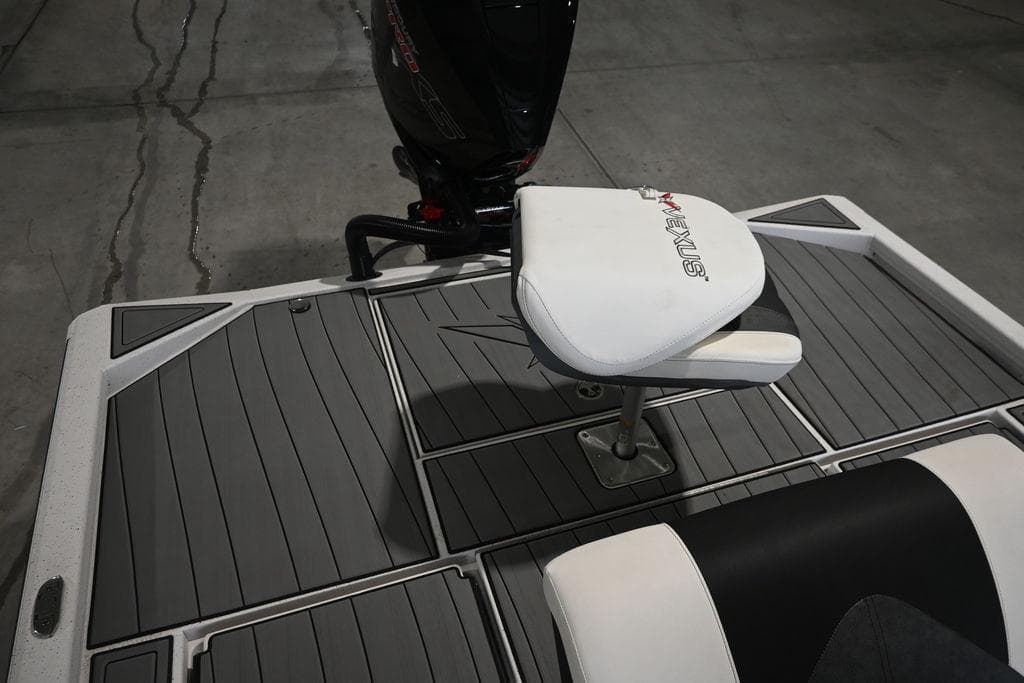 2023 Vexus AVX2180CC boat deck with seating and motor, featuring sleek design.