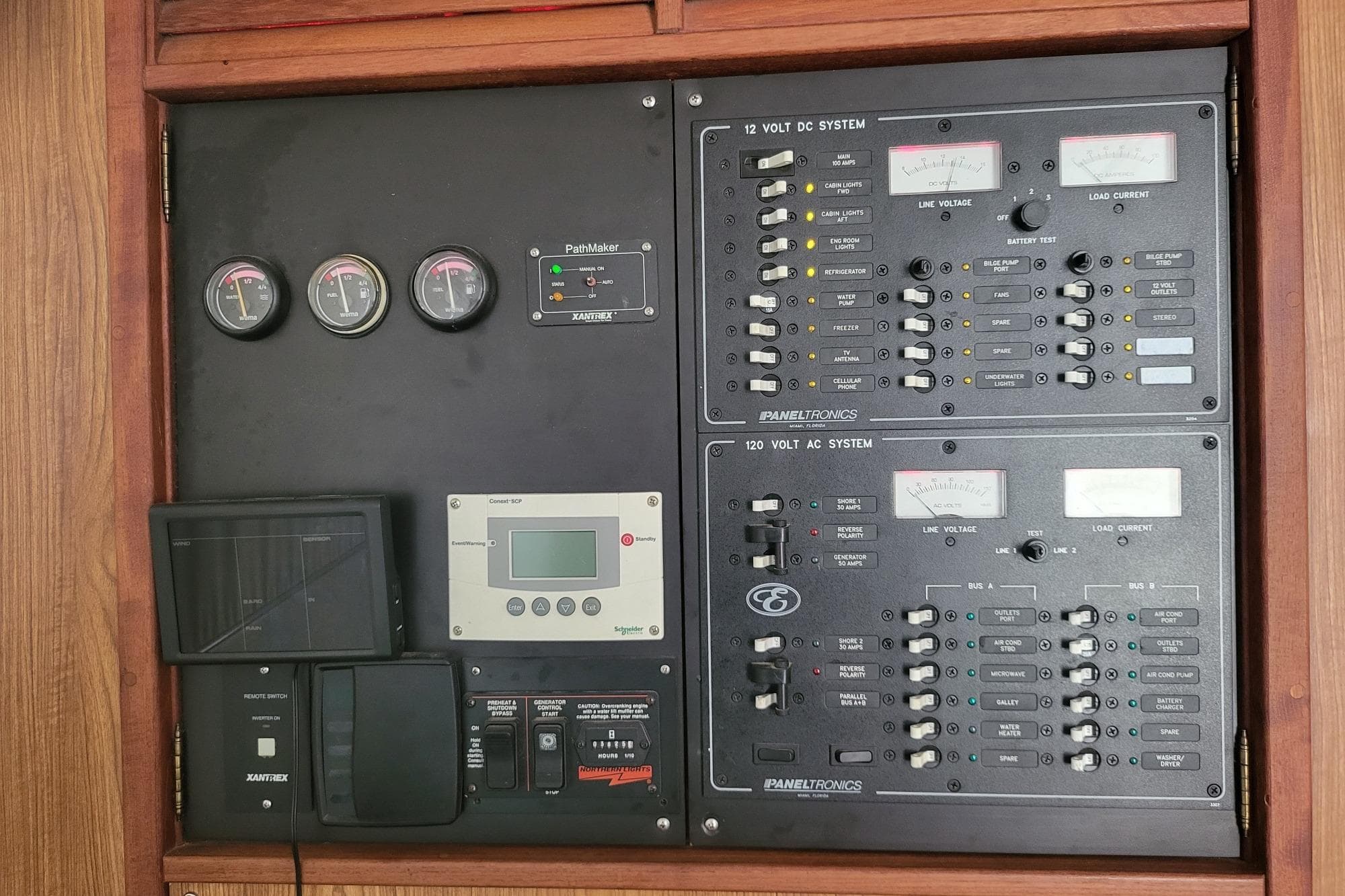 Electrical control panel of a 2006 Endeavour 40 Trawler Catamaran, featuring gauges and switches.