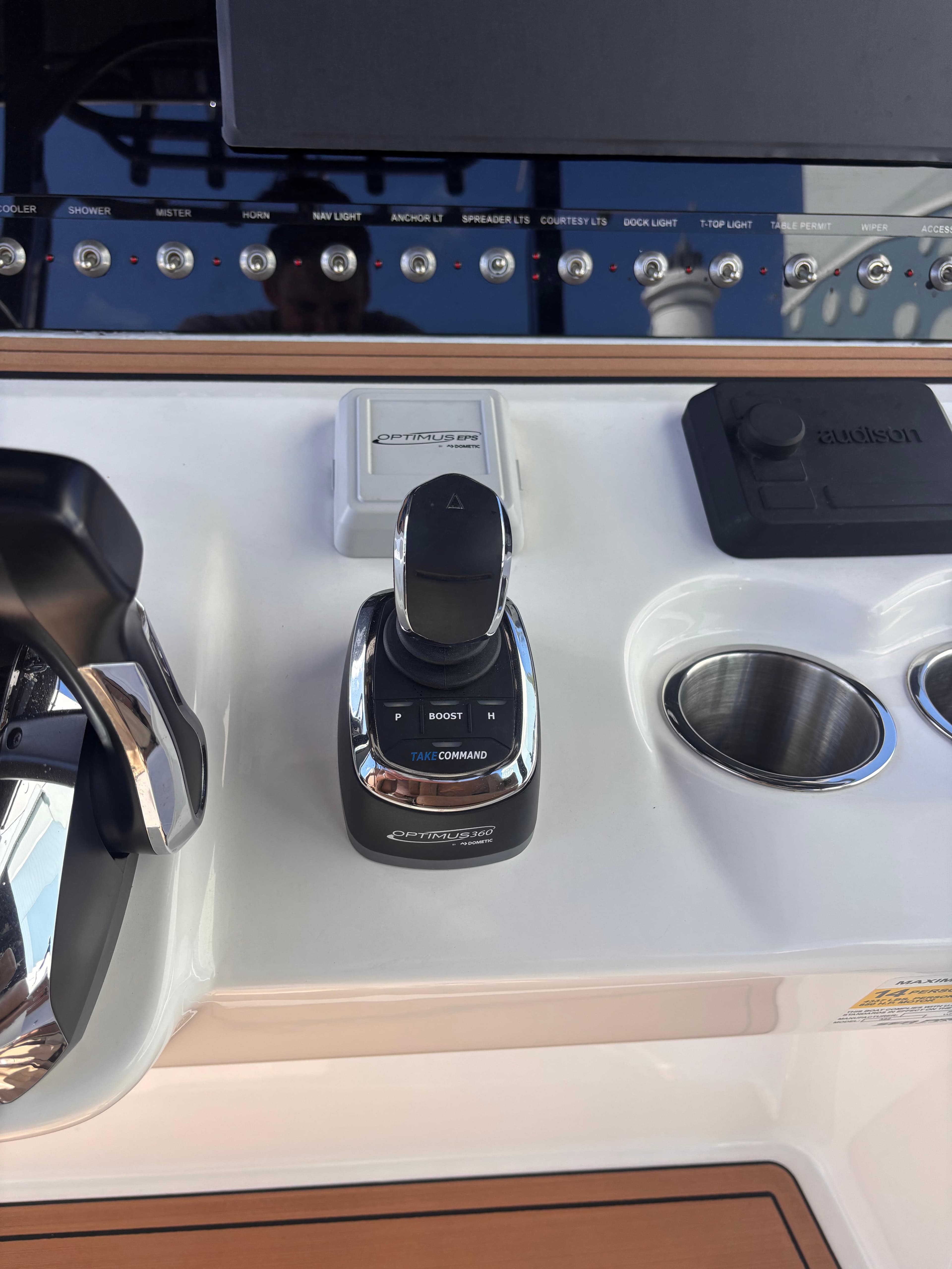 2024 Sea Pro 322 DLX Offshore boat control panel with joystick and cup holders.