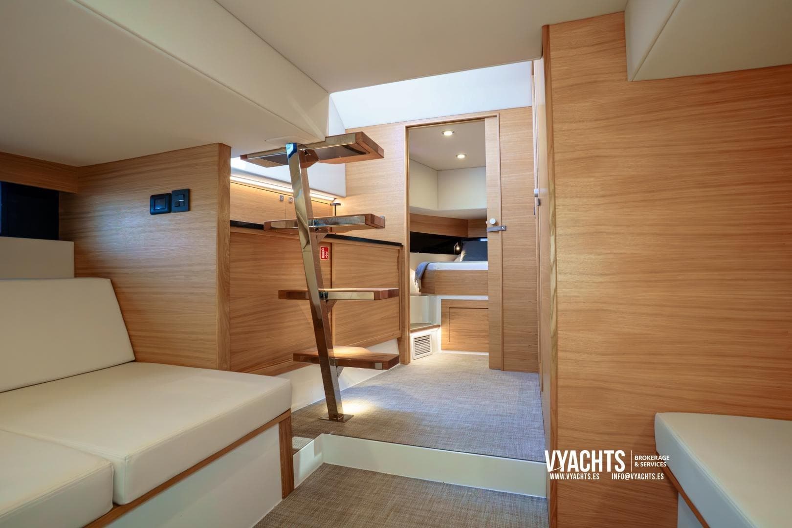 Luxurious interior of 2024 De Antonio Yachts D42 Open, featuring modern wood finishes and cozy seating.