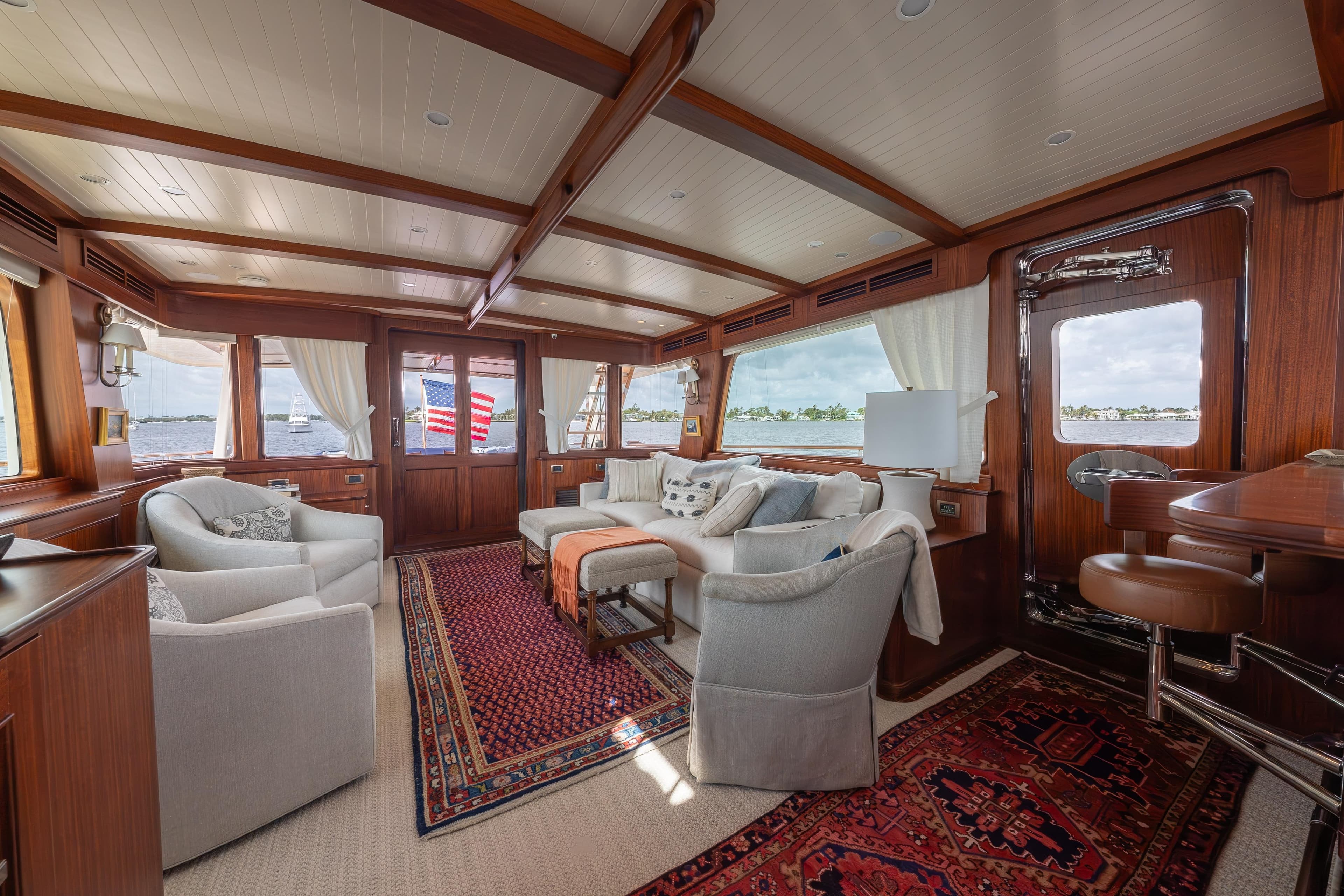 Luxurious interior of 2022 Hunt Ocean 76EP yacht with elegant seating and wooden accents.