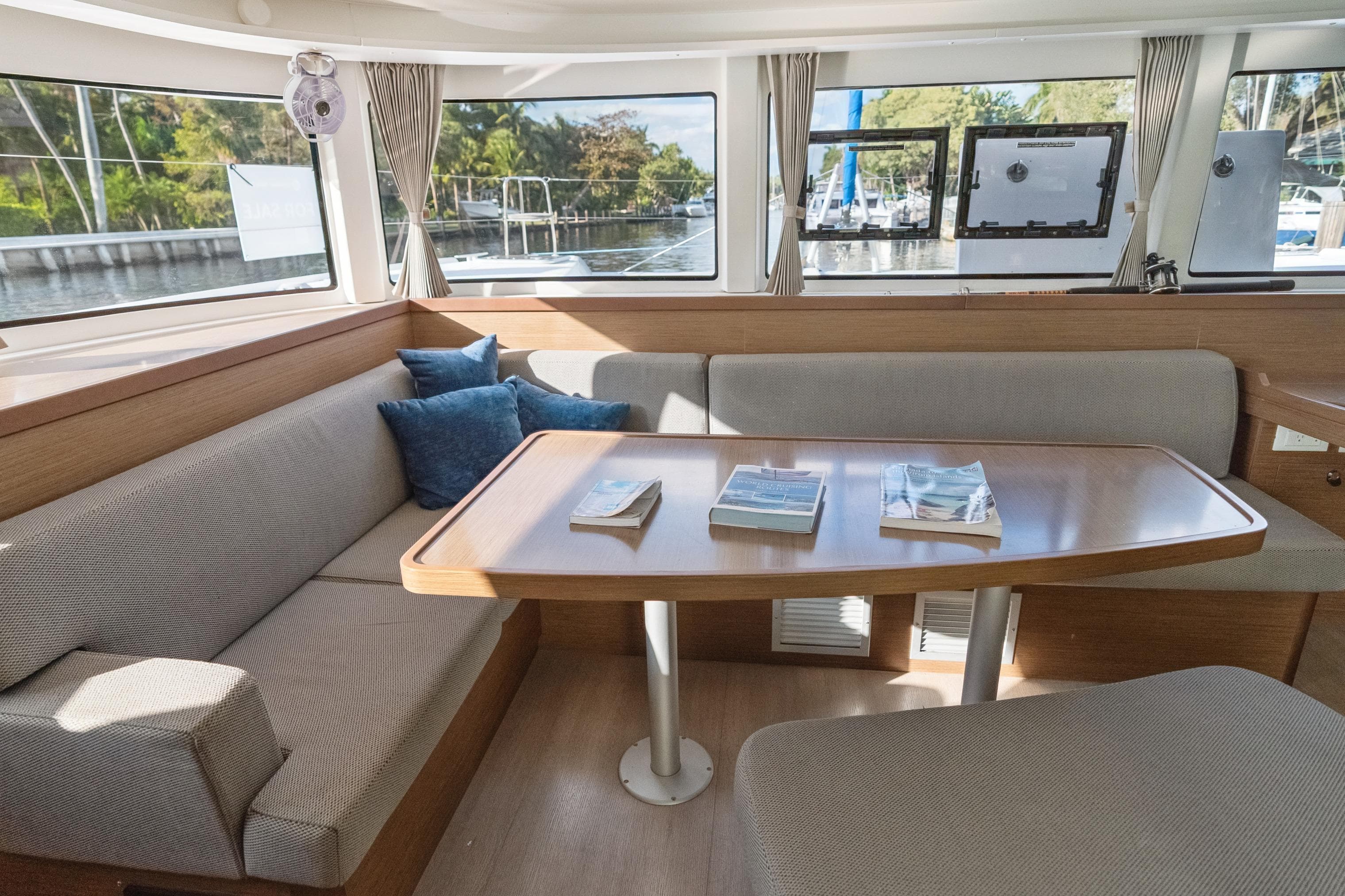 Interior of 2020 Lagoon 42 catamaran with cozy seating and wooden table.