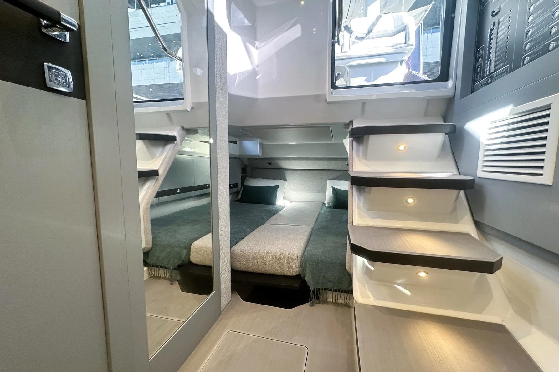 Luxurious interior of 2026 Marco E-MOTION 44 yacht with modern design and cozy sleeping area.
