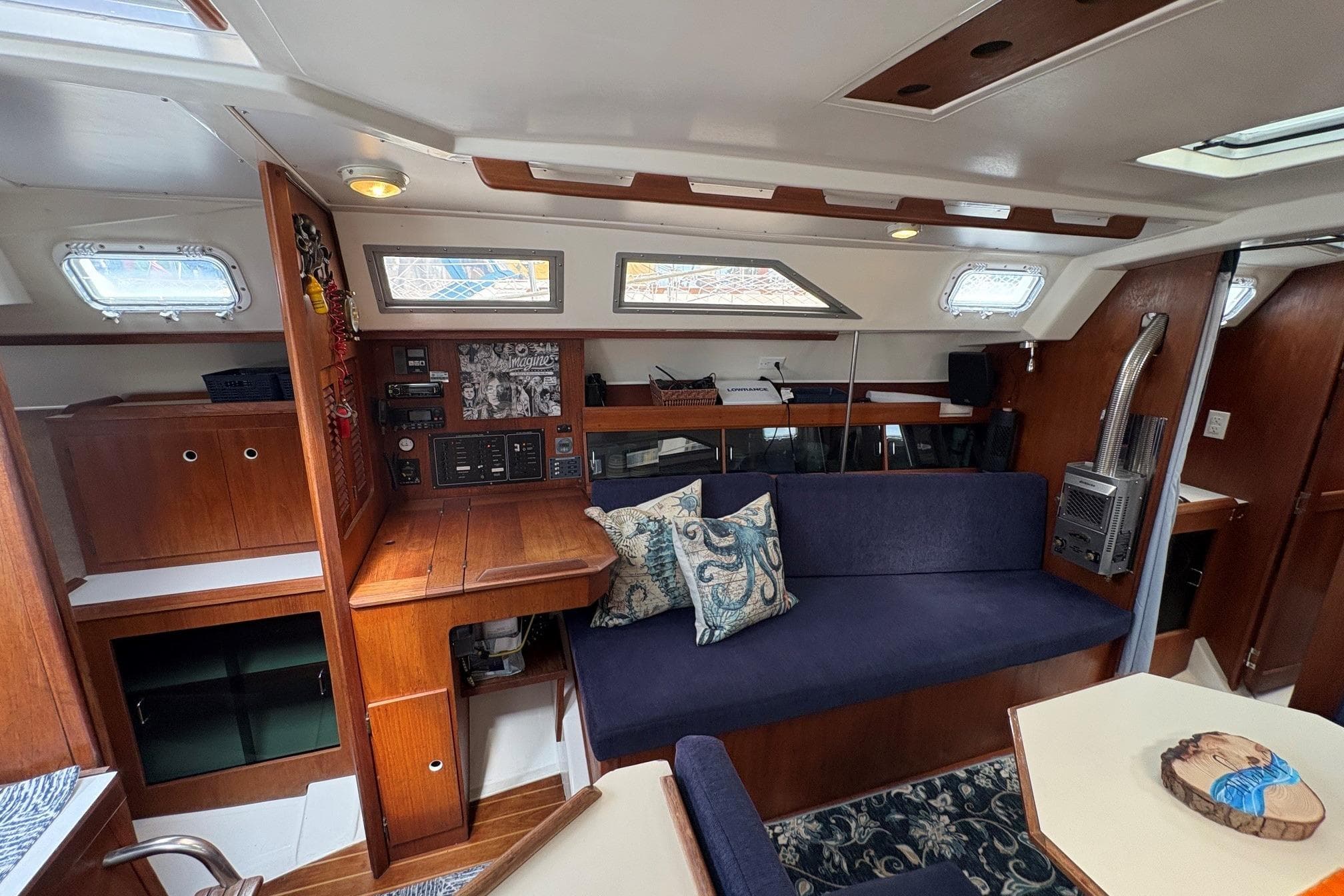 Interior of 1984 Hunter 34 sailboat with wood paneling and blue seating.