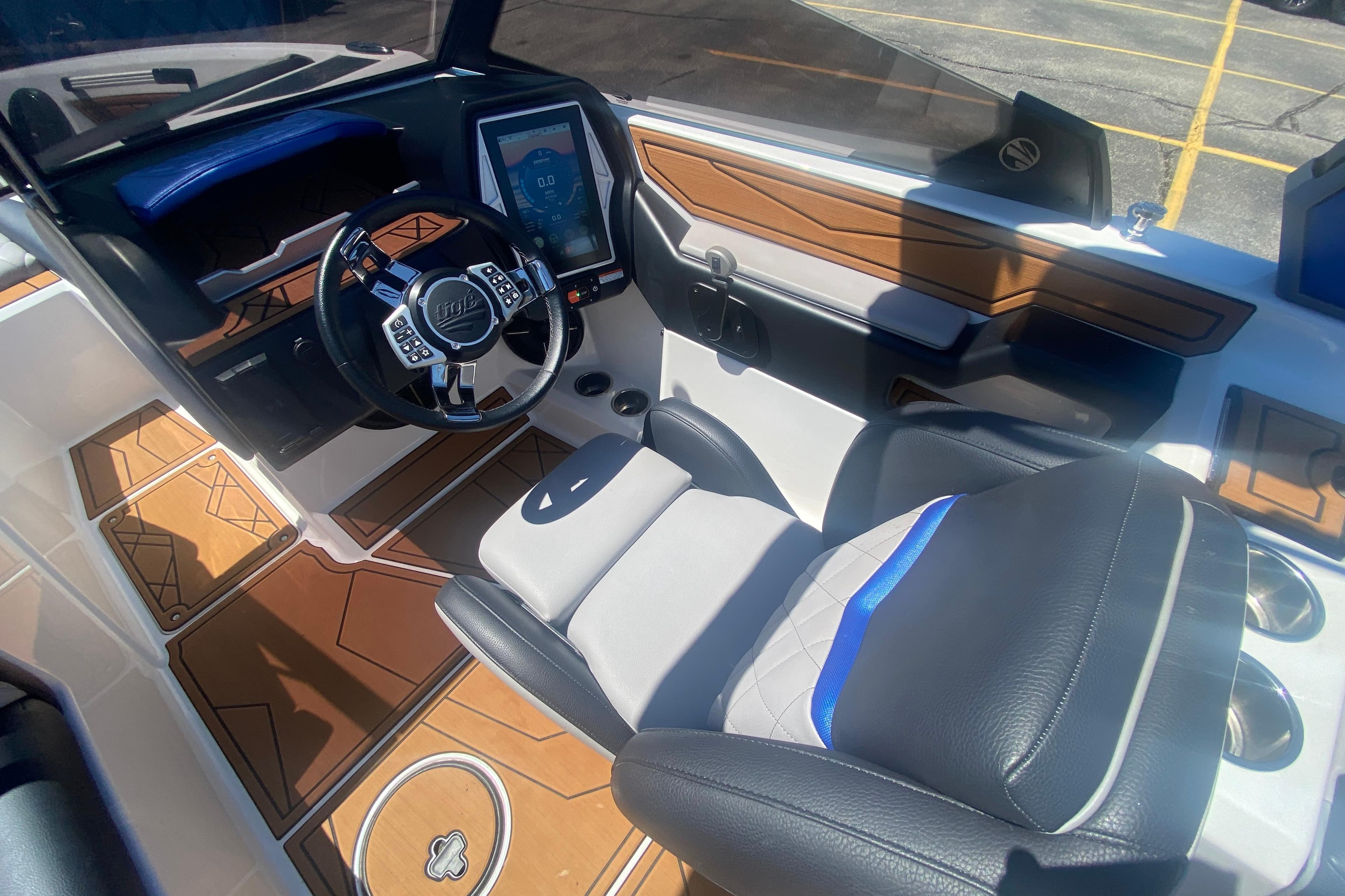 Interior of a 2021 Tigé Z3 boat featuring a modern dashboard and luxurious seating.