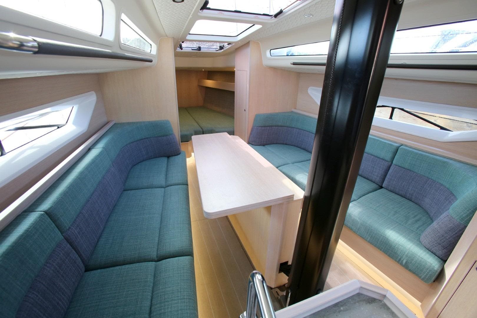 Modern interior of 2025 Shogun 43 yacht with blue seating and sleek design.