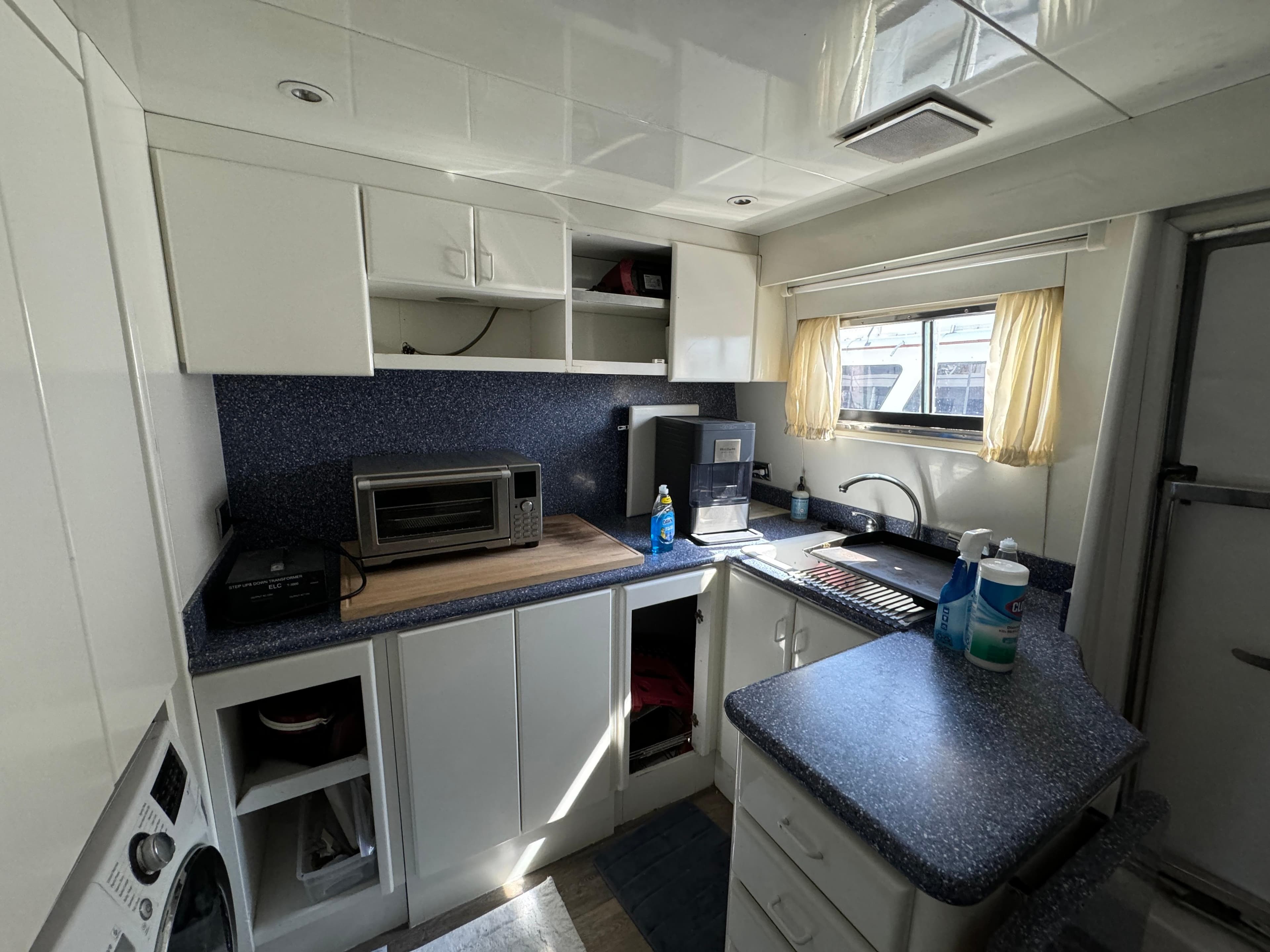 1990 Versilcraft Challenger Motor Yacht kitchen with modern appliances and white cabinetry.