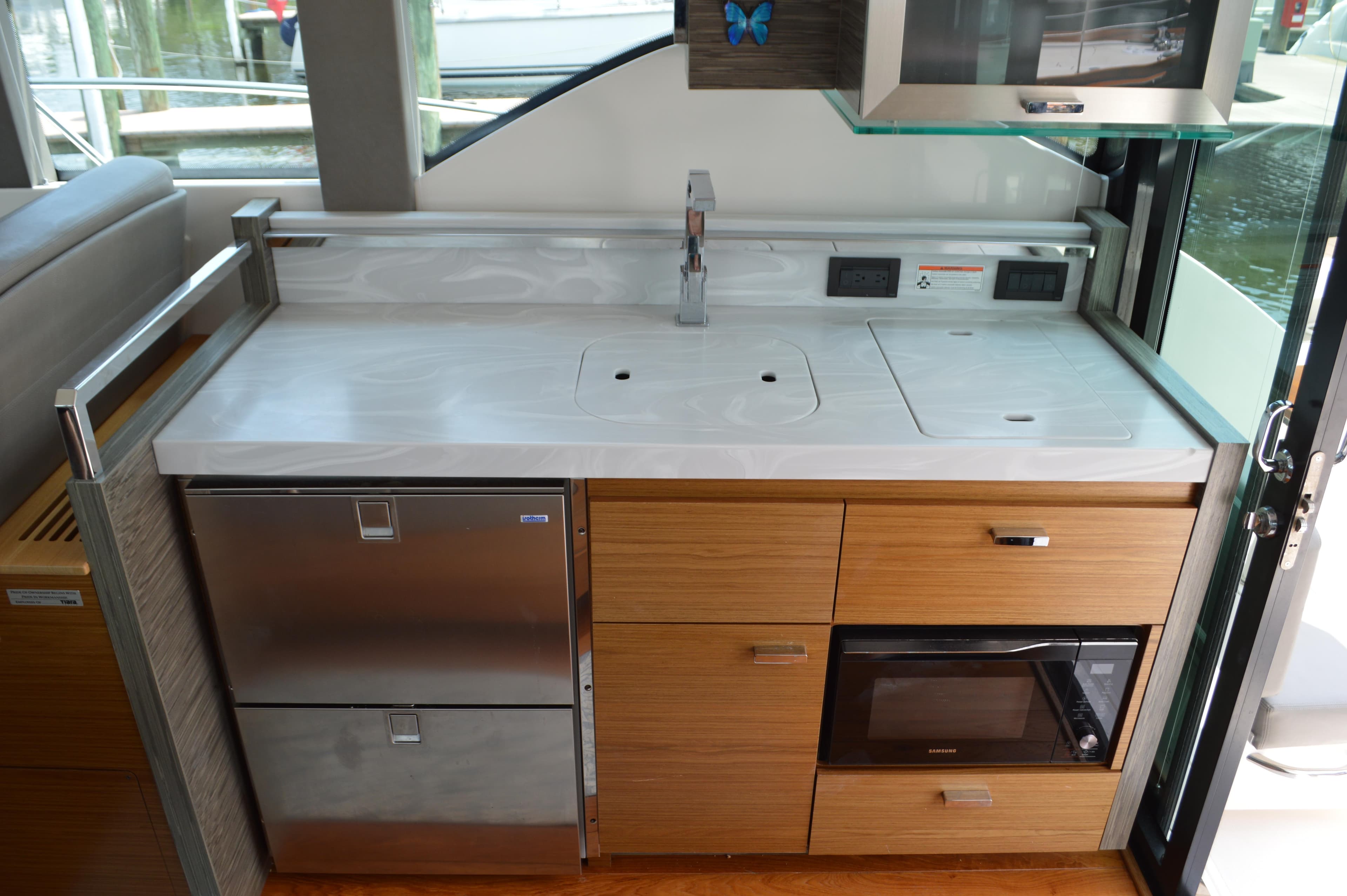 Modern kitchen area in 2019 Tiara Yachts C39 Coupe with sleek appliances and cabinetry.