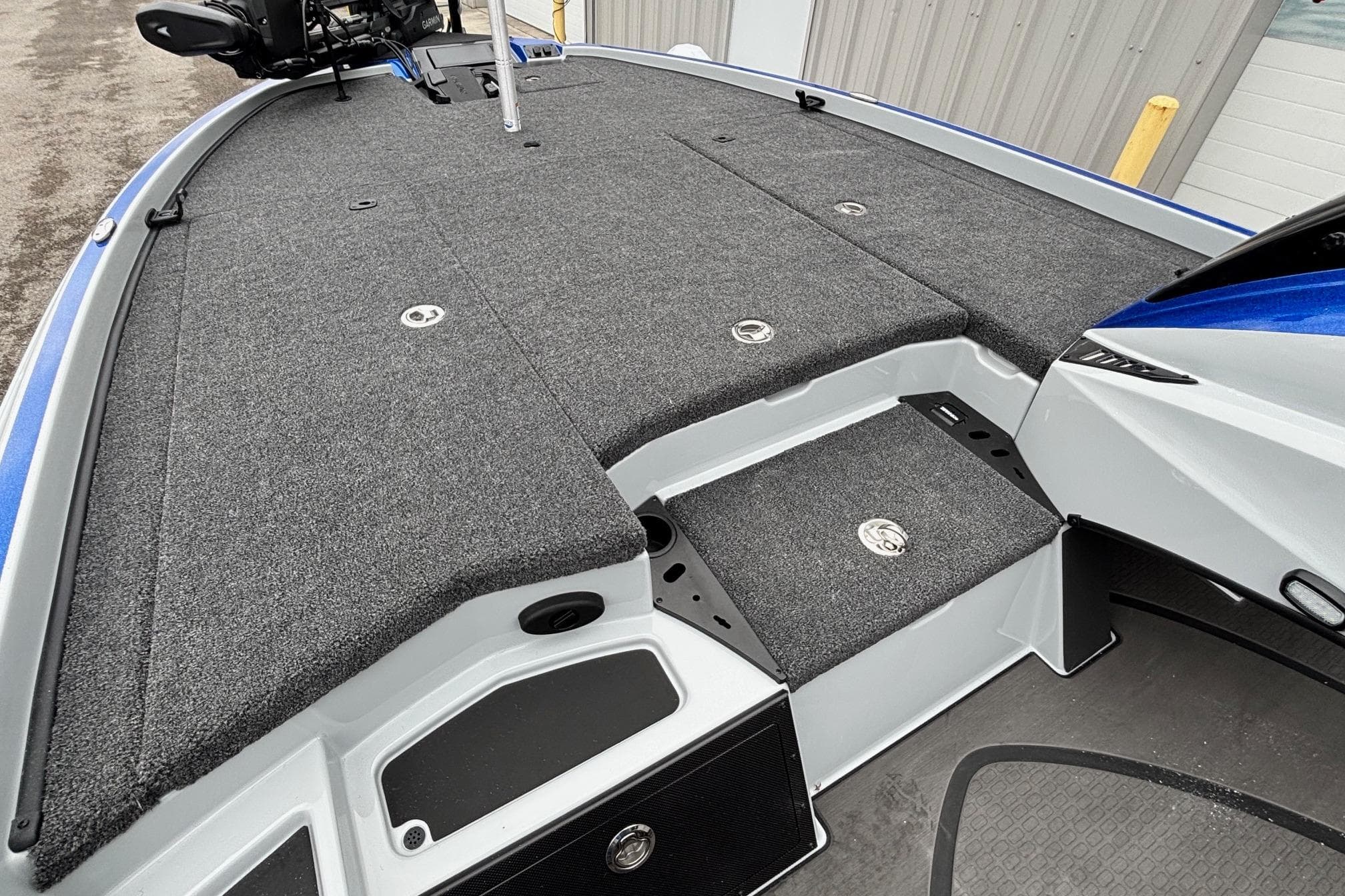 2026 Triton 20XP Patriot boat deck with gray carpet and storage compartments.
