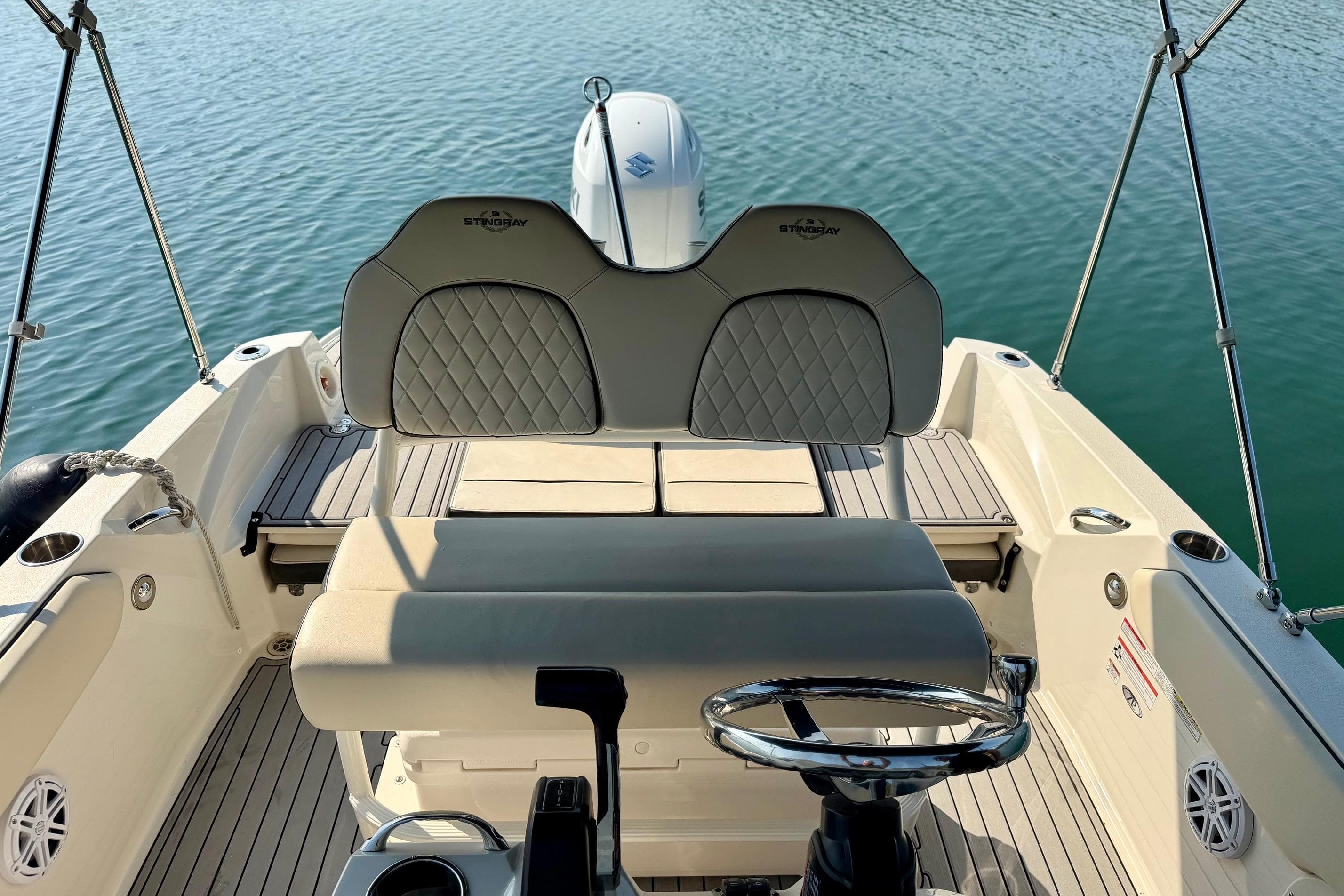 2022 Stingray 206 CC boat interior with steering wheel and cushioned seating.