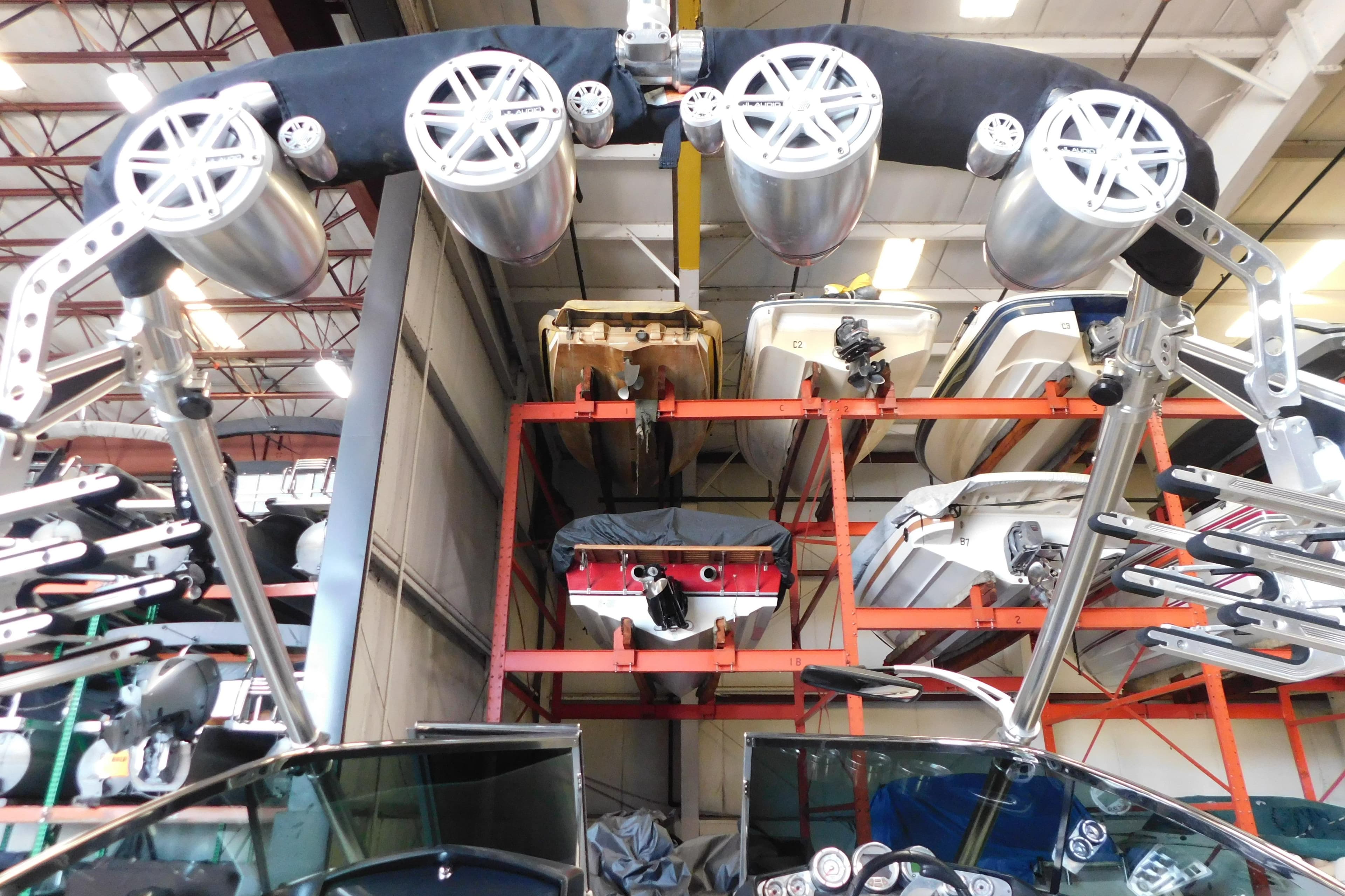 Indoor storage of 2009 MasterCraft X55 boats with mounted speakers and equipment.