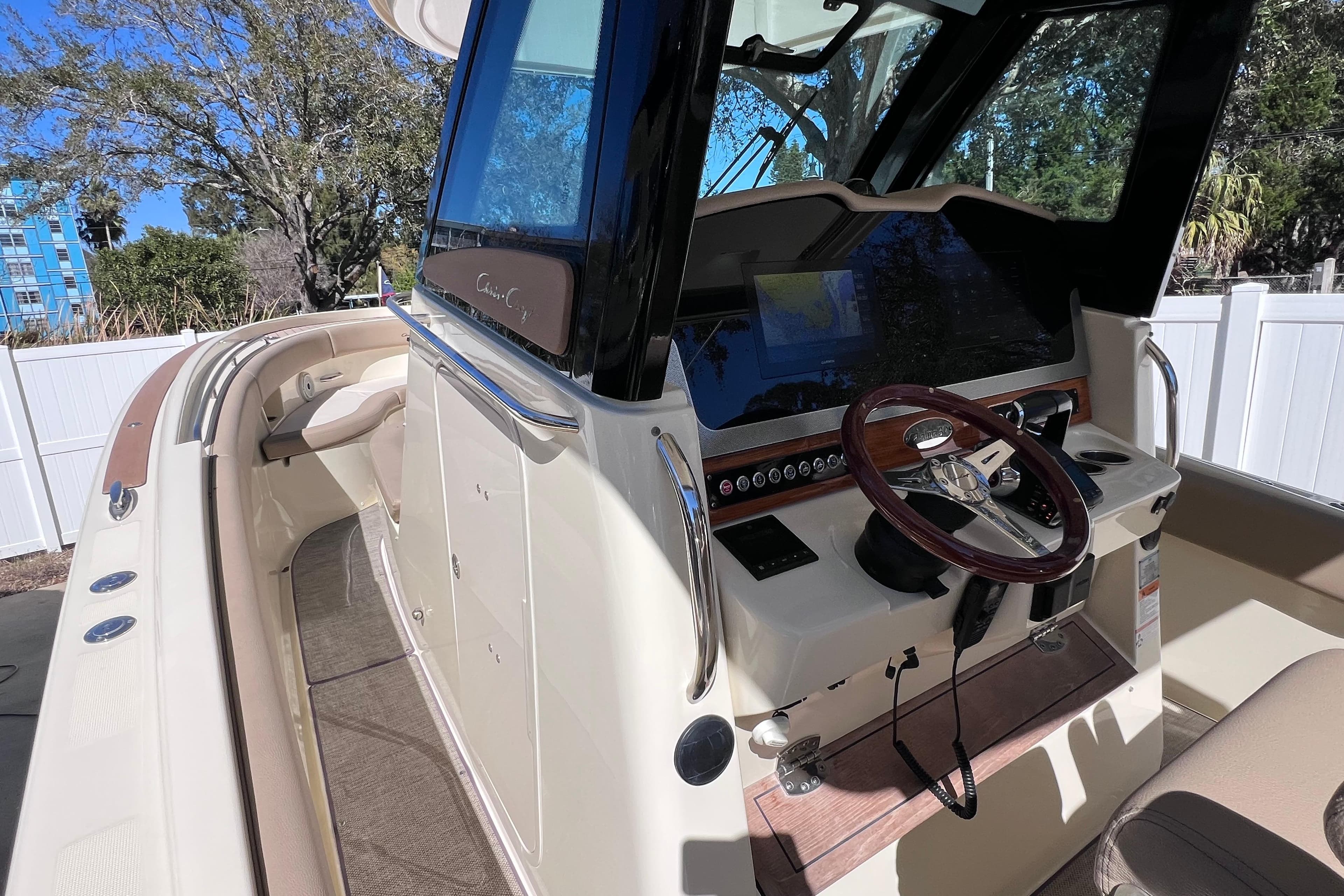 2022 Chris-Craft Catalina 30 boat interior with steering wheel and navigation system.