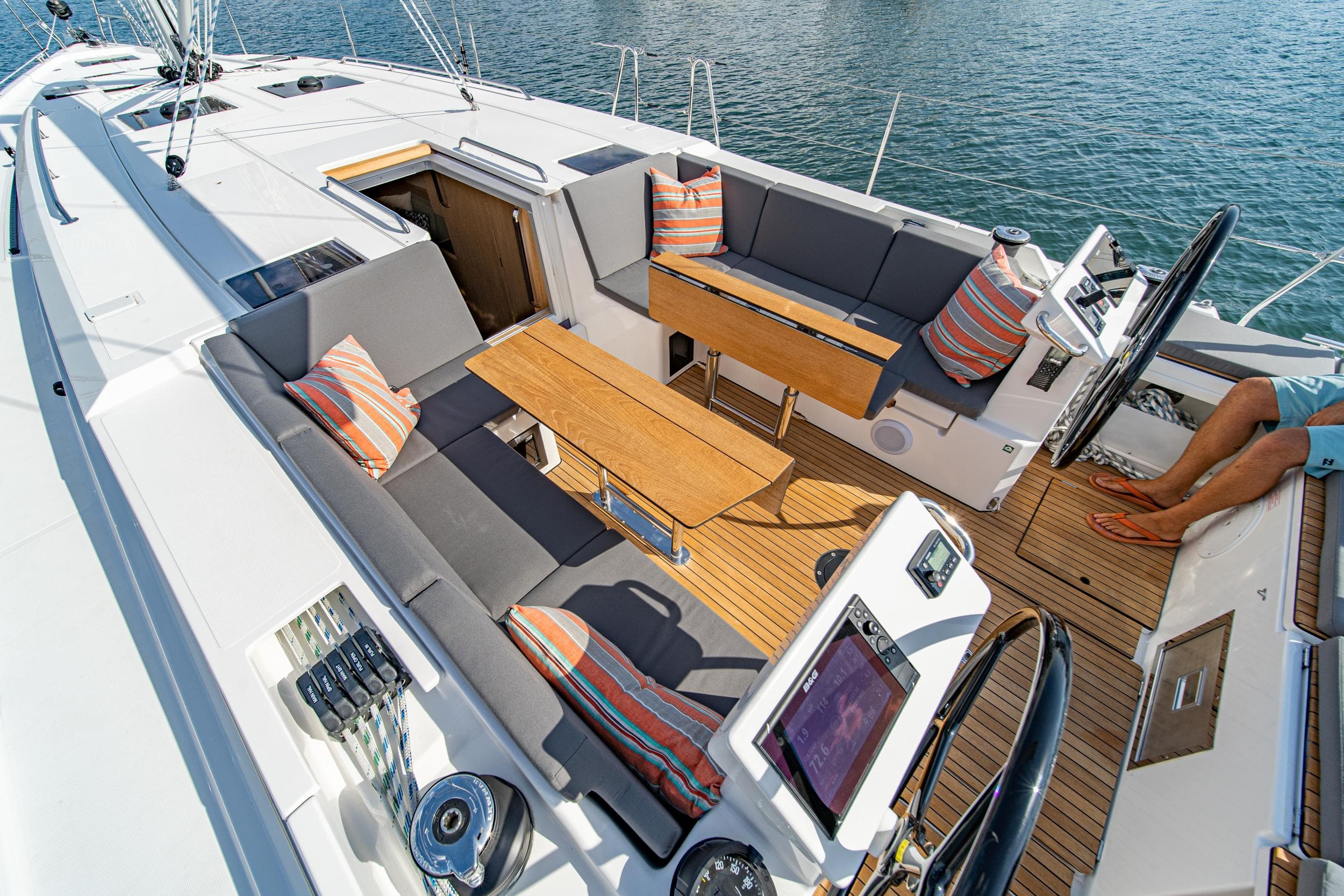 2024 Bavaria C45 yacht cockpit with seating, wooden table, and nautical controls.